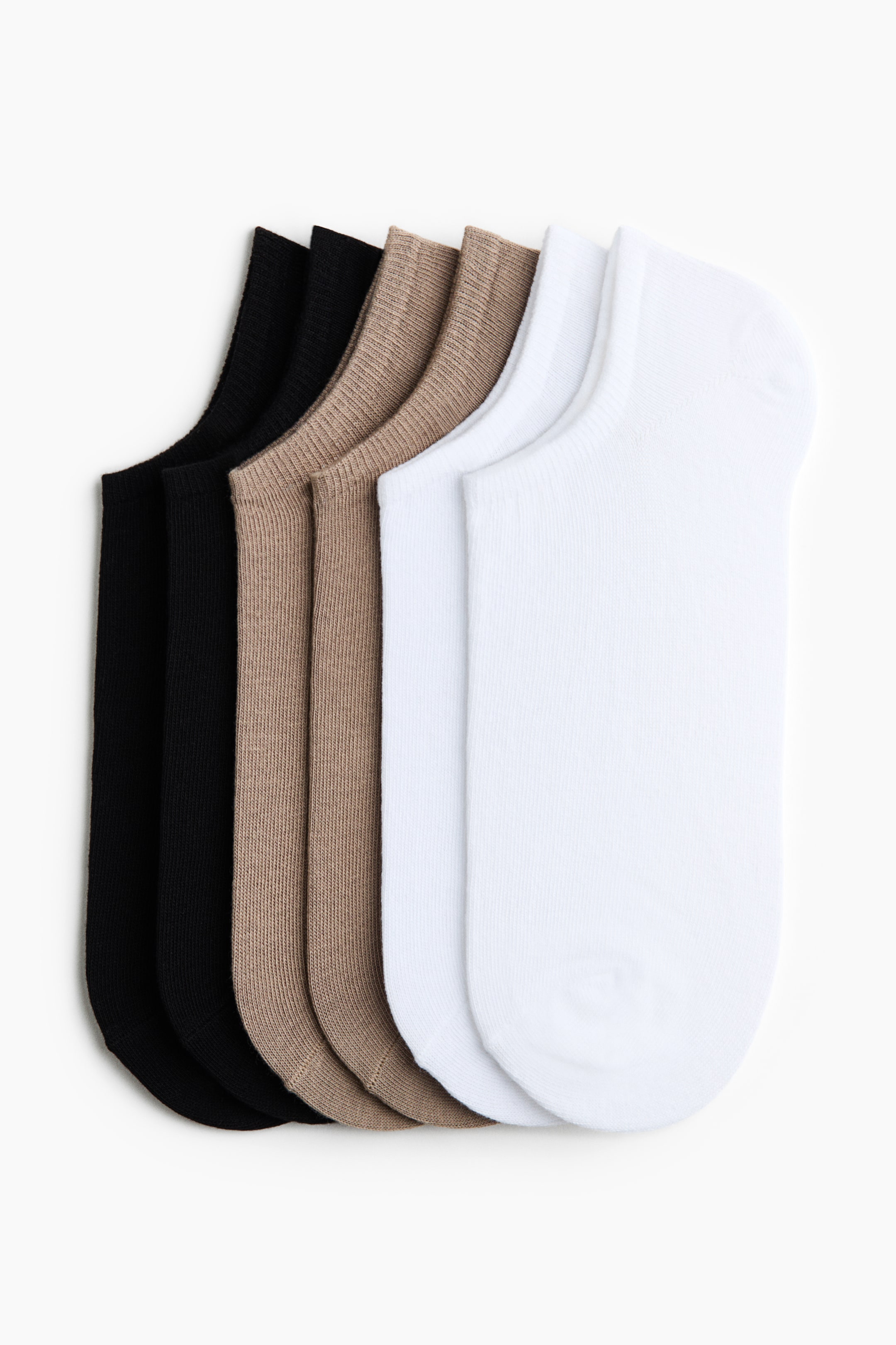 View larger image: A set of six no-show socks fans out diagonally, displaying six individual socks in black, beige, and white. The black and beige socks feature a ribbed knit, while the white socks present a smoother, flat knit.