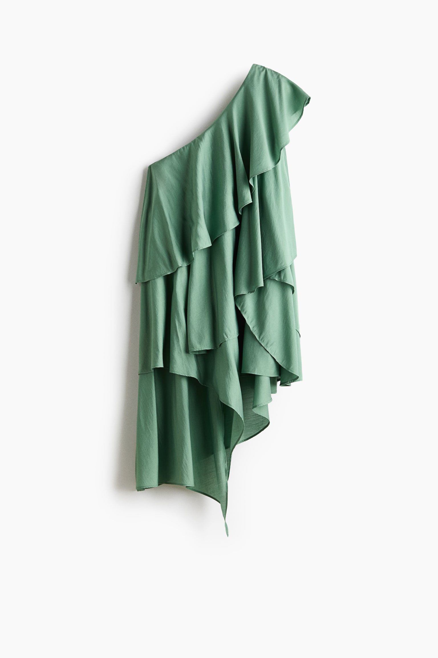 A sage green one-shoulder top features multiple cascading ruffles and a draped, asymmetrical hem.