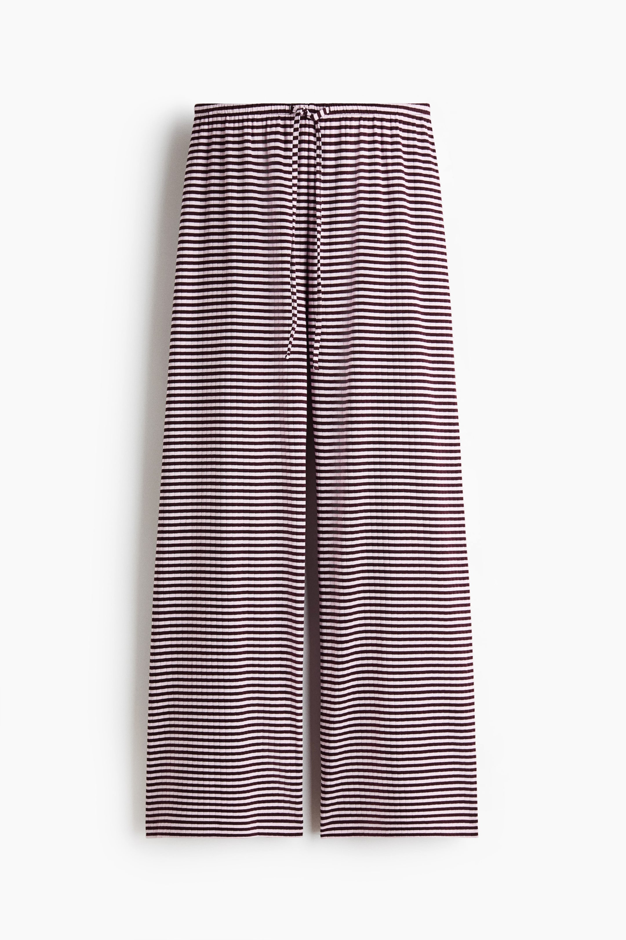 View larger image: Loose-fit trousers are displayed from the front, showcasing a ribbed cotton jersey fabric with contrasting horizontal dark red and off-white stripes. Designed with an elasticated waist and a visible drawstring tied at the front.