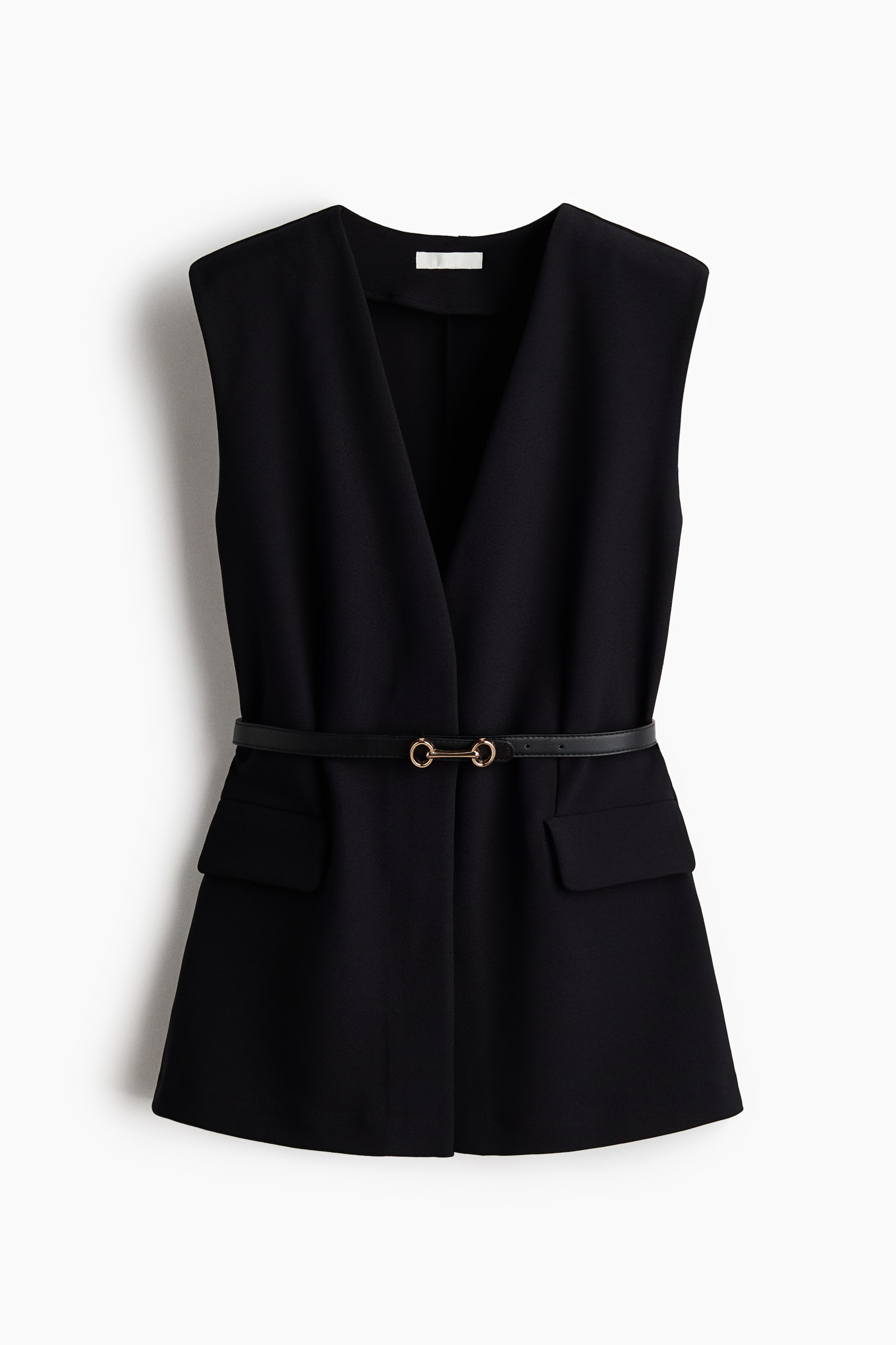 View larger image: A black sleeveless long-line vest is presented from the front, featuring a deep V-neckline and two flap pockets on the lower front. A thin black belt with a gold-toned double-ring buckle cinches the waist of the vest.