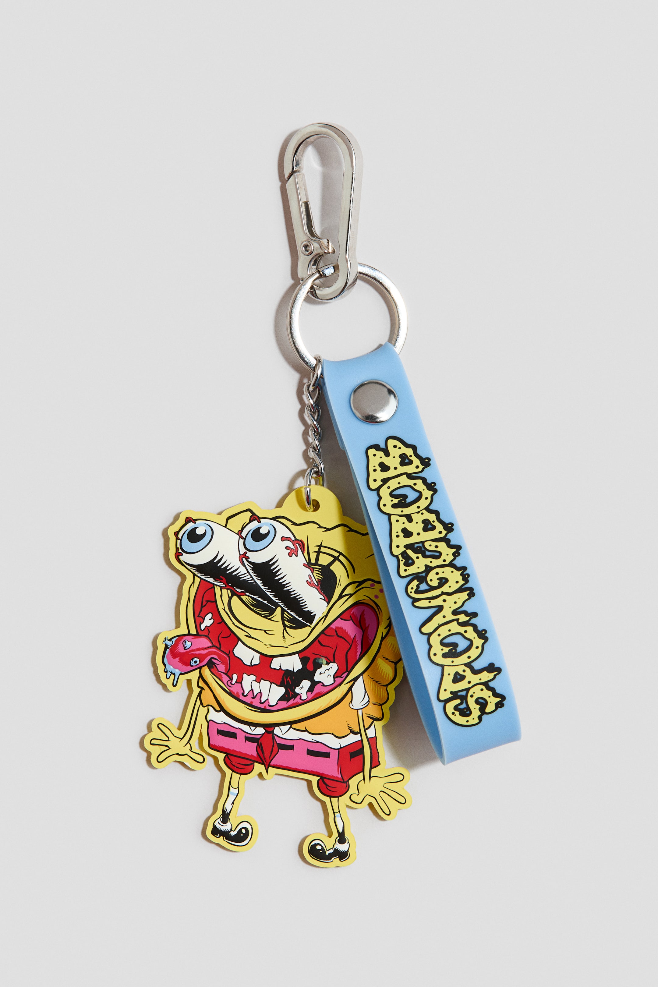 Voir une image plus grande: Un porte-clés doté d'un mousqueton argenté, d'une lanière bleu clair avec le texte "SPONGEBOB" en relief jaune, et d'un charme de personnage orienté vers l'avant, jaune, rouge et rose. Le charme de personnage représente une version grotesque de Bob l'éponge avec des yeux exorbités et injectés de sang et une bouche grande ouverte.