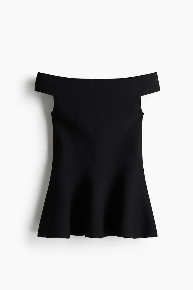 A black off-the-shoulder top is being displayed from the front, featuring a wide ribbed band across the shoulders. The top is sleeveless, and its body is gently flaring out towards the hem. - 1
