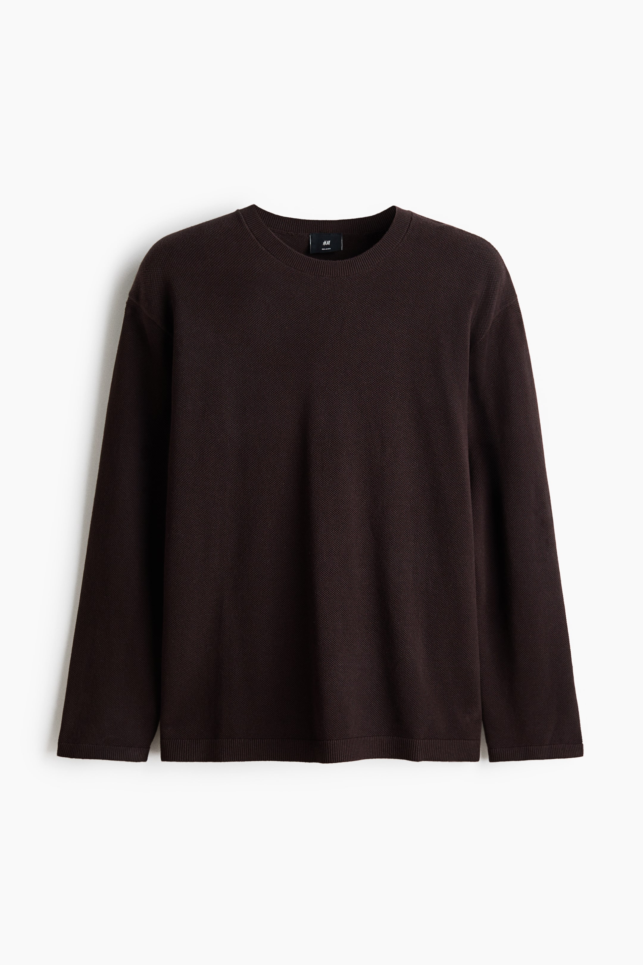 View larger image: A dark brown crew-neck sweater is shown from the front, featuring a subtle waffle-knit texture. It is designed with long sleeves, ribbed cuffs, and a ribbed hem.