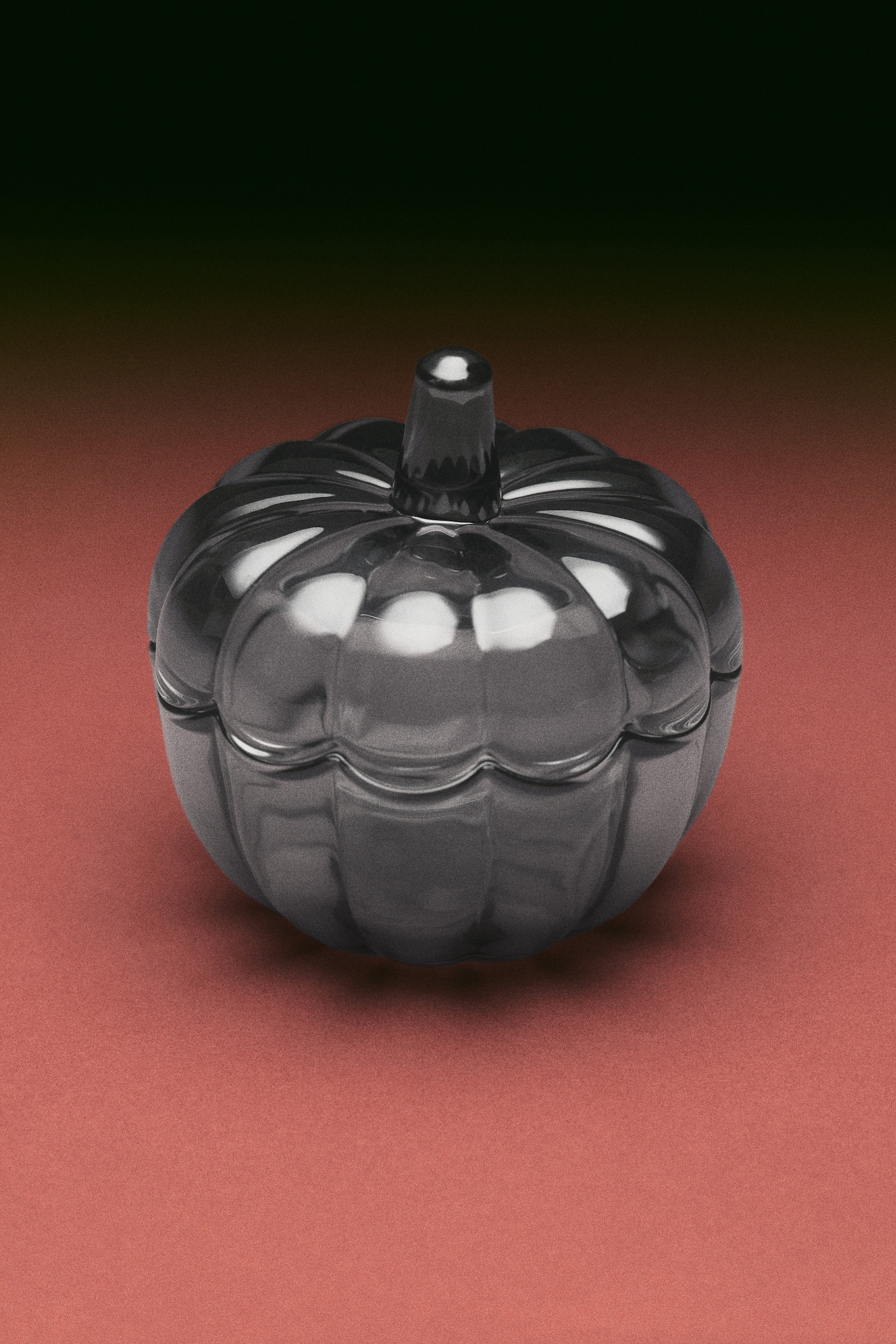 A small, translucent dark grey glass jar with a lid features a pumpkin design, showcasing ribbed sections forming its body and a stem-like handle on the lid. - 1