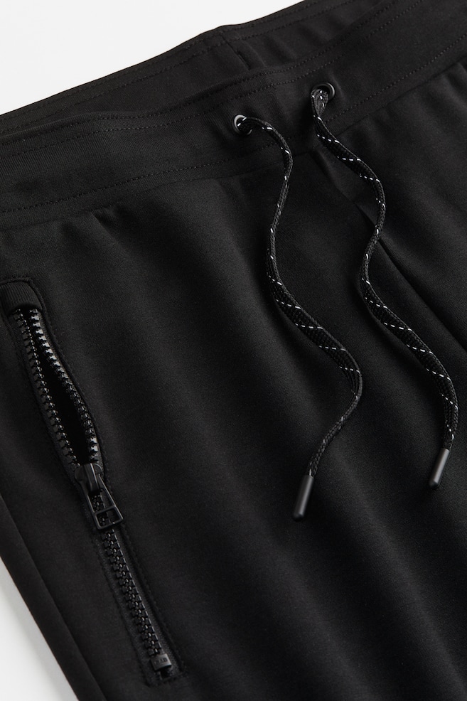 DryMove™ Tapered tech joggers with zipped pockets - Black/Light grey marl/Dark red/Block-coloured/Black/dc - 3