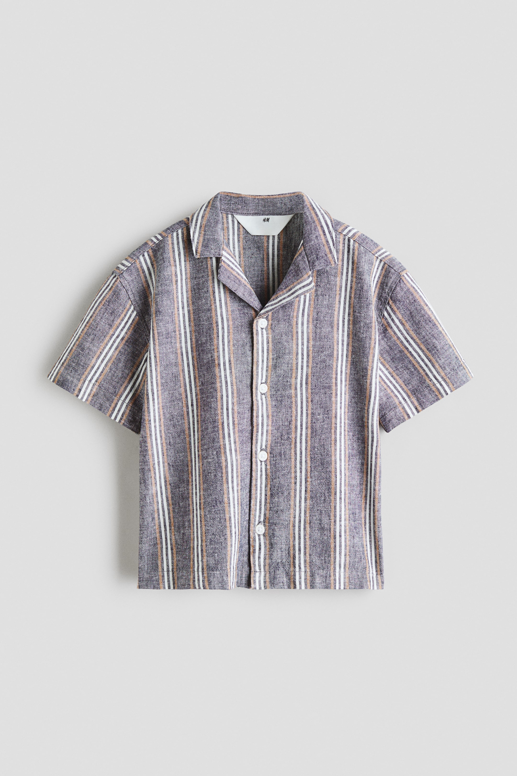 View larger image: A short-sleeved shirt featuring a camp collar and a full button-front closure with white buttons, designed with vertical stripes in white, light brown, and charcoal grey.