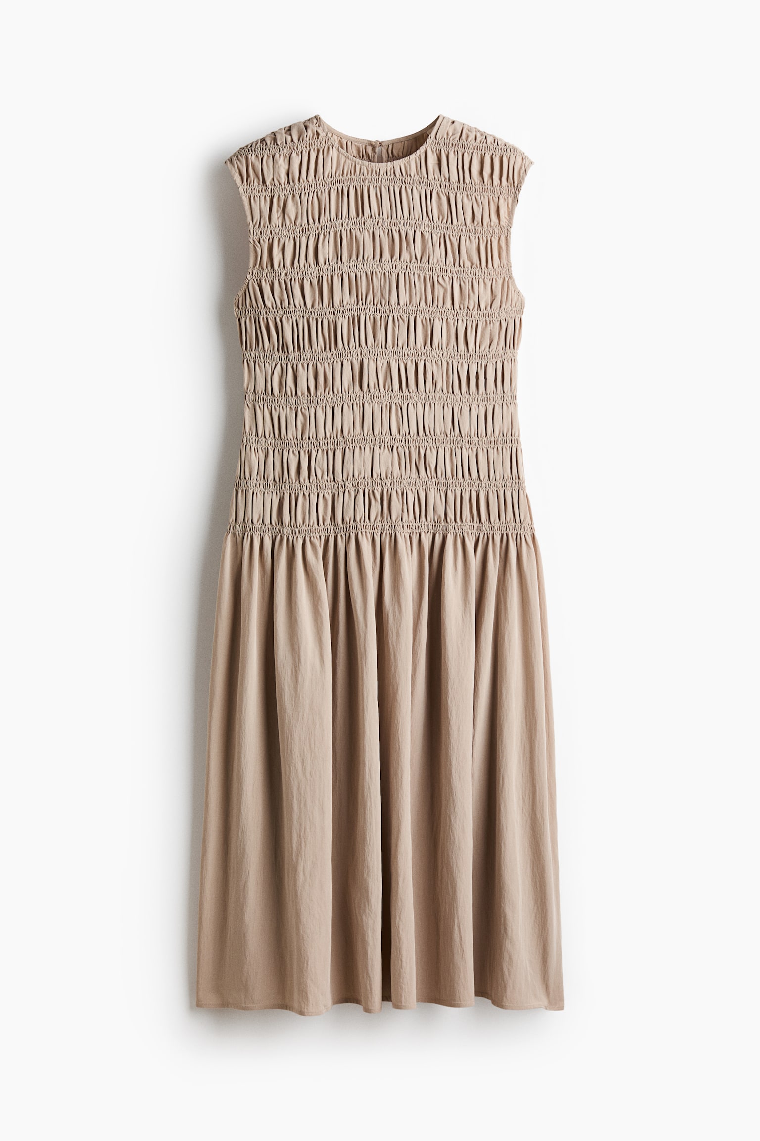 "The beige sleeveless dress showcases a front view, highlighting its bodice which is fully smocked from the round neckline down to a gathered waistline, smoothly transitioning into a flowing A-line skirt." - 1