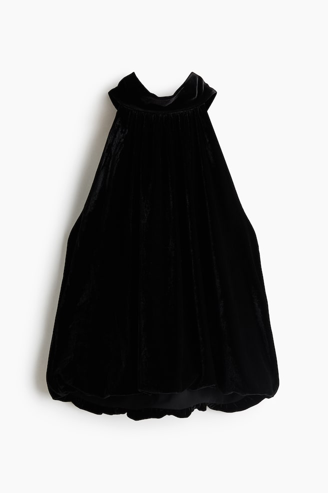 A black velvet halter top is facing front, showcasing a gathered high collar, a voluminous sleeveless silhouette, and a draped bubble hem. - 1