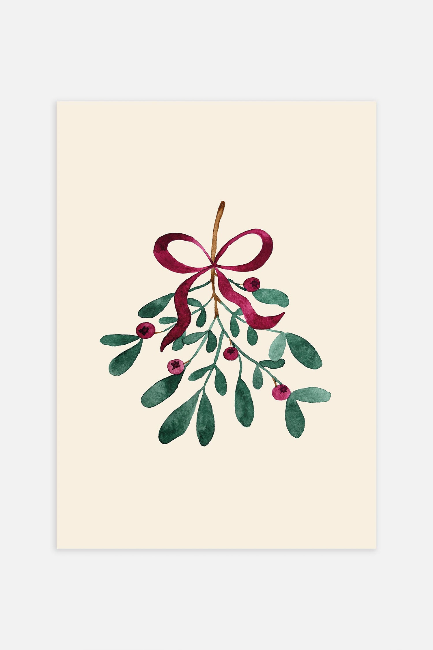 A vertically oriented rectangular art print showcases a watercolour illustration of a bunch of mistletoe tied with a burgundy ribbon bow on a cream-coloured background. The artwork is enclosed within a light-coloured wooden frame featuring a natural grain.