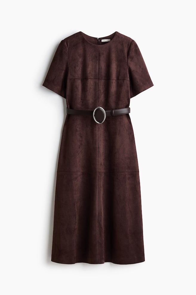 A front-facing, dark brown calf-length dress features a soft, napped texture, a round neckline and short sleeves. The dress has visible horizontal and vertical seams on the front bodice and skirt, and is styled with a matching dark brown waist belt with a silver-toned, oval buckle. - 1