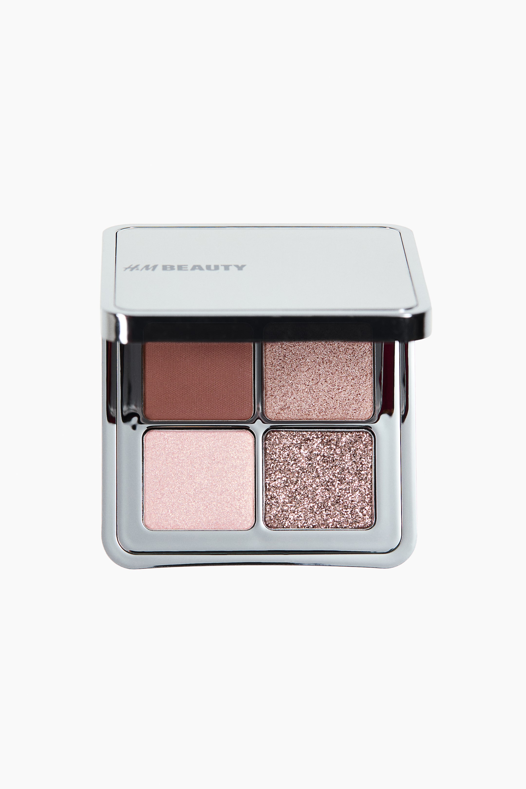 View larger image: A silver-toned, square eyeshadow compact is presented front-facing with its lid open. Inside, four square pans are displaying a matte reddish-brown, a shimmery light rose gold, a shimmery light pink, and a glittery rose gold eyeshadow.