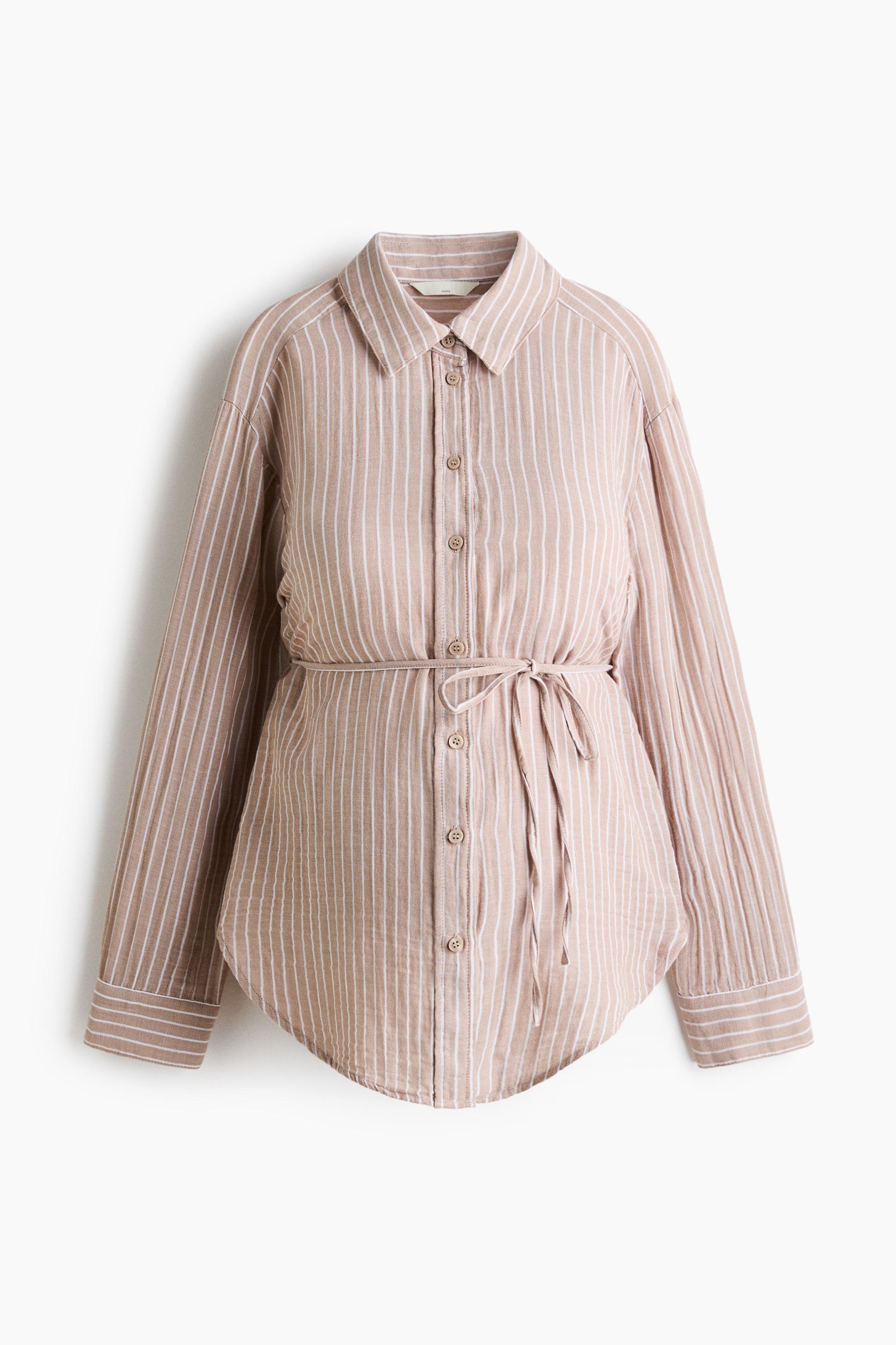 View larger image: A beige and white vertically striped long-sleeved shirt is shown from the front, with a classic collar and a full button-front closure. A matching fabric tie belt cinches the waist, and the shirt features buttoned cuffs on the long sleeves and a curved hem.
