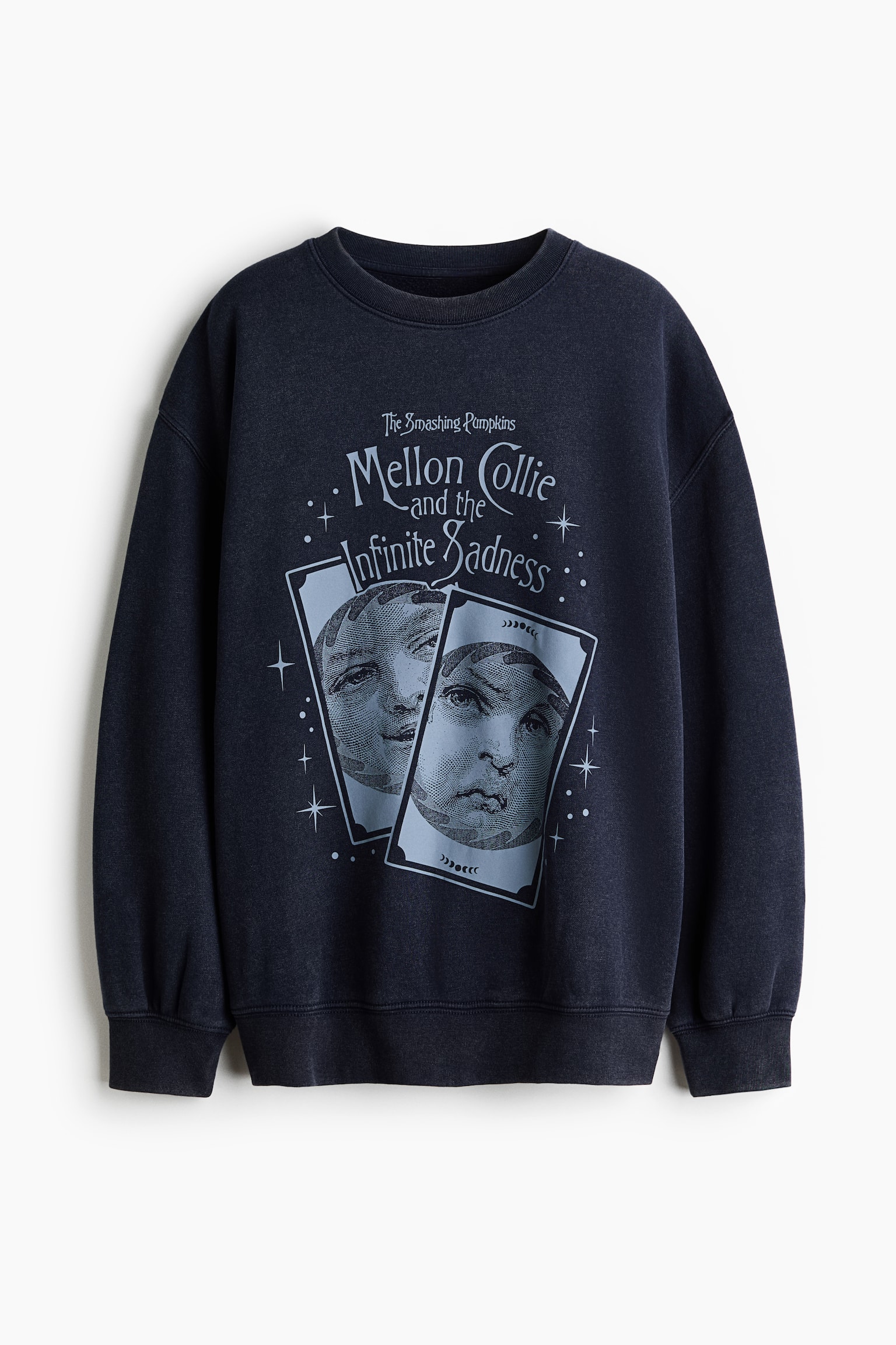 A front-facing, oversized dark navy blue sweatshirt featuring a light blue graphic print of The Smashing Pumpkinsâ Mellon Collie and the Infinite Sadness artwork on the chest. The sweatshirt has a ribbed crew neck, dropped shoulders, and long sleeves with ribbed cuffs and a ribbed hem.