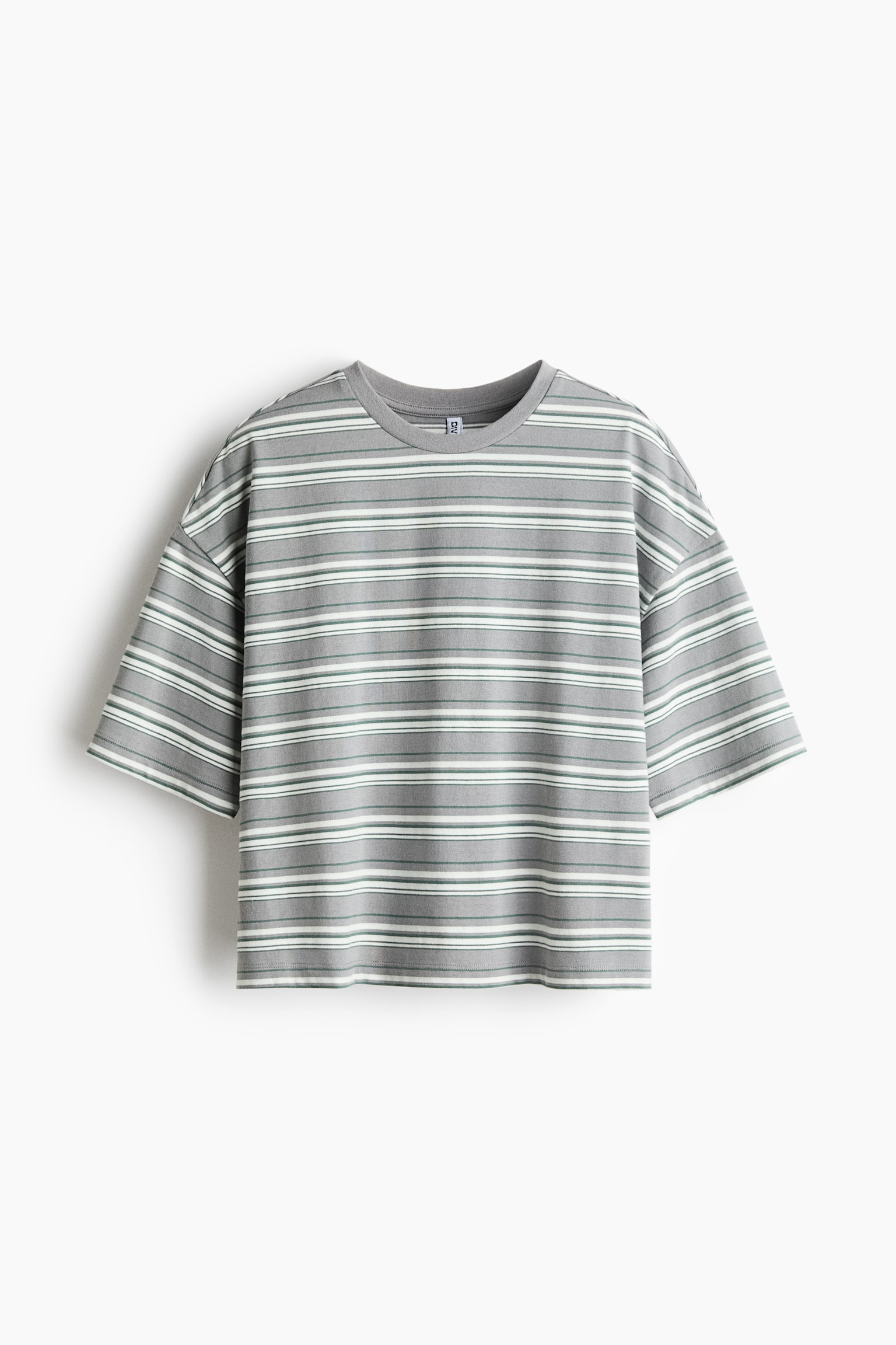 A horizontal-striped T-shirt is shown from the front, featuring a relaxed, oversized silhouette with dropped shoulders and wide, elbow-length sleeves. The top features alternating horizontal stripes in grey, white, and thin green, complemented by a ribbed crew neck and a straight hem.