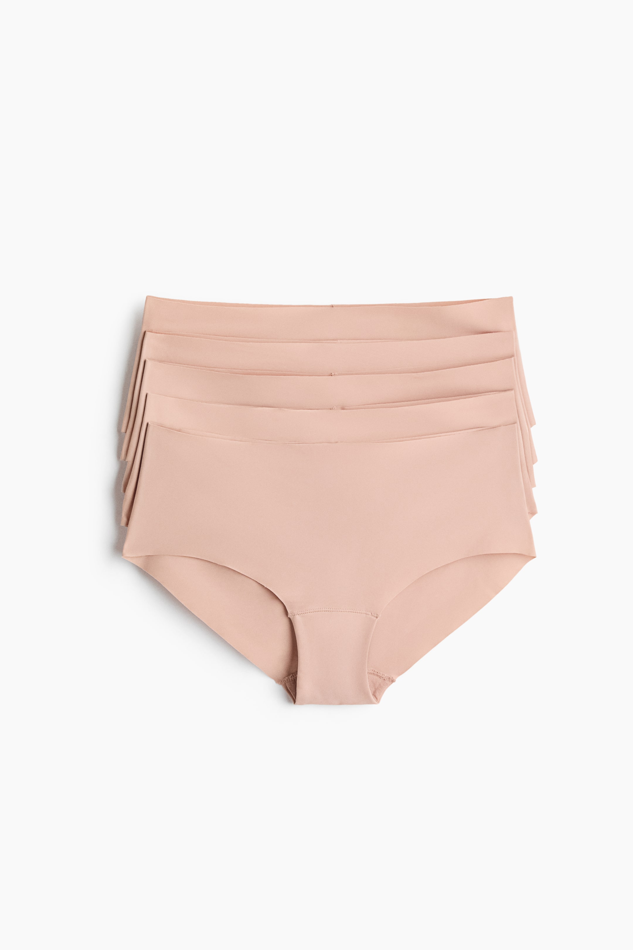 Visualizza immagine più grande: Cinque paia di slip hipster senza cuciture, in delicato rosa cipria, sono disposti distesi e rivolti verso il fronte, impilati in una composizione leggermente sfalsata per mostrare ogni elastico in vita. Gli slip mettono in evidenza un tessuto liscio ed elasticizzato con bordi grezzi tagliati al laser per un design senza cuciture.
