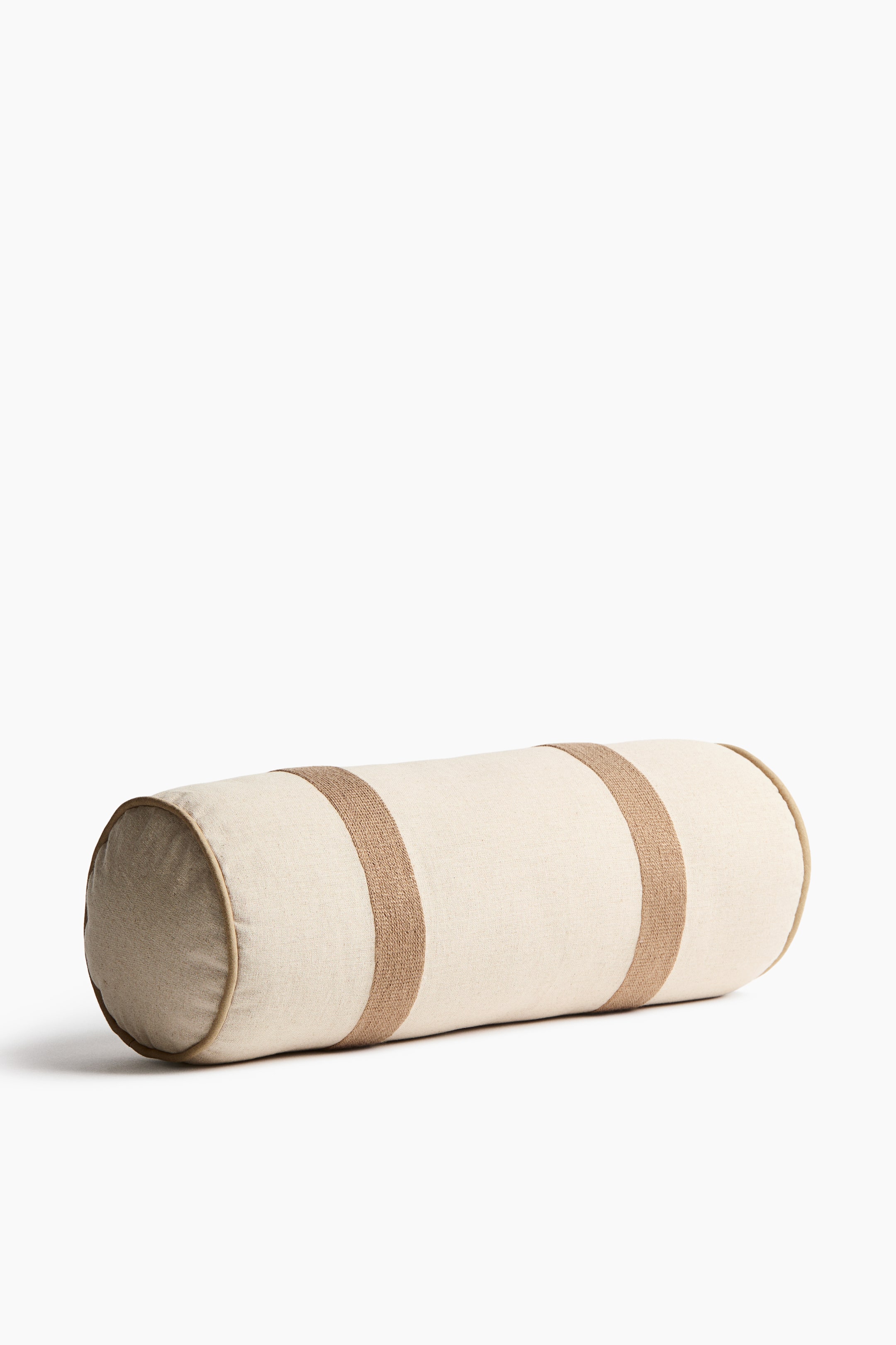 View larger image: A bolster is displayed from the front, crafted from a rustic linen and cotton blend with a visible weave. It is designed with broad, embroidered stripes and piping at the sides.