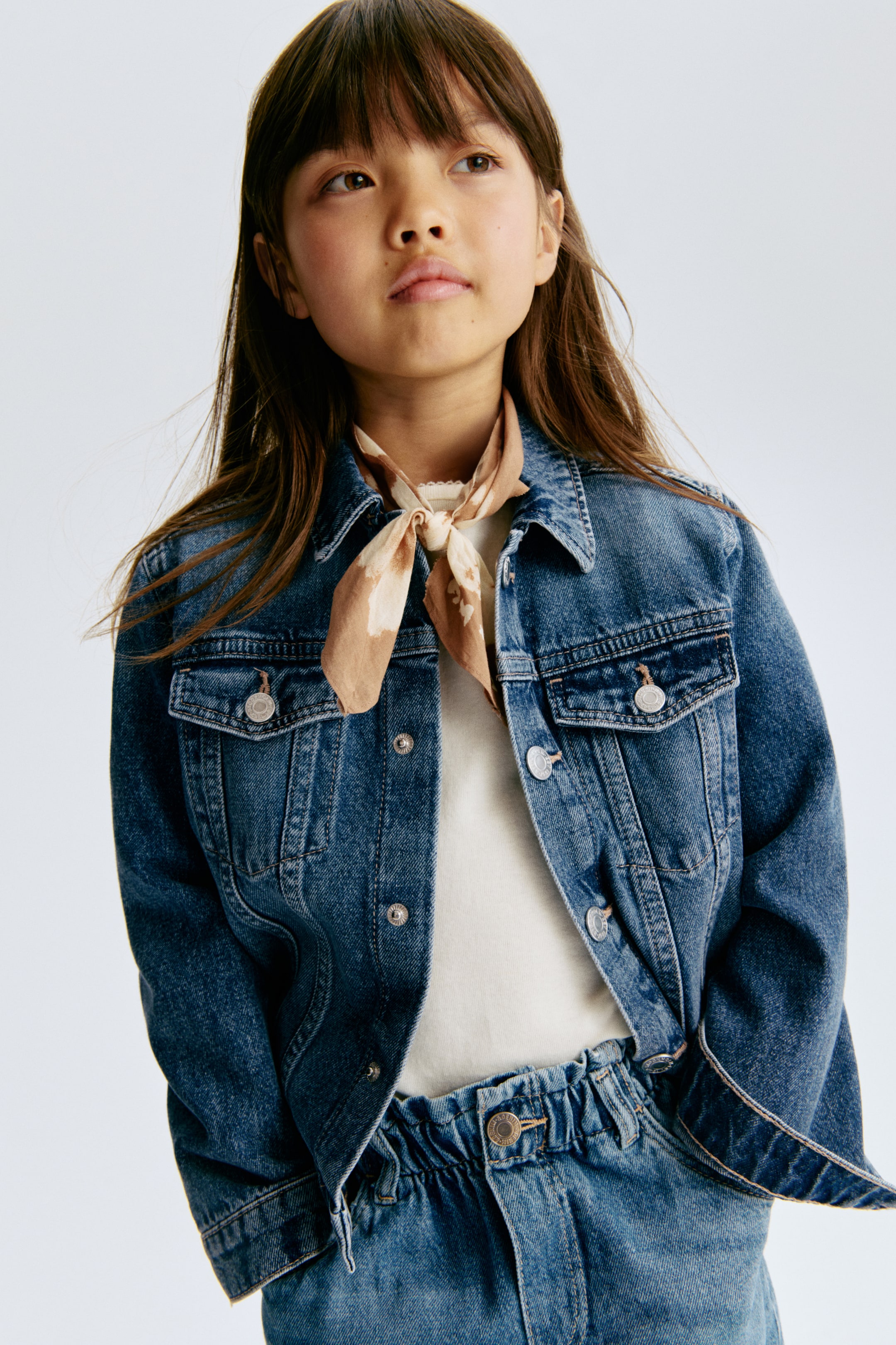 View larger image: A timeless jacket crafted from soft cotton denim, showcasing a turn-down collar, press-studs along the front and on the cuffs, complemented by decorative chest pockets, each adorned with a flap and a press-stud.