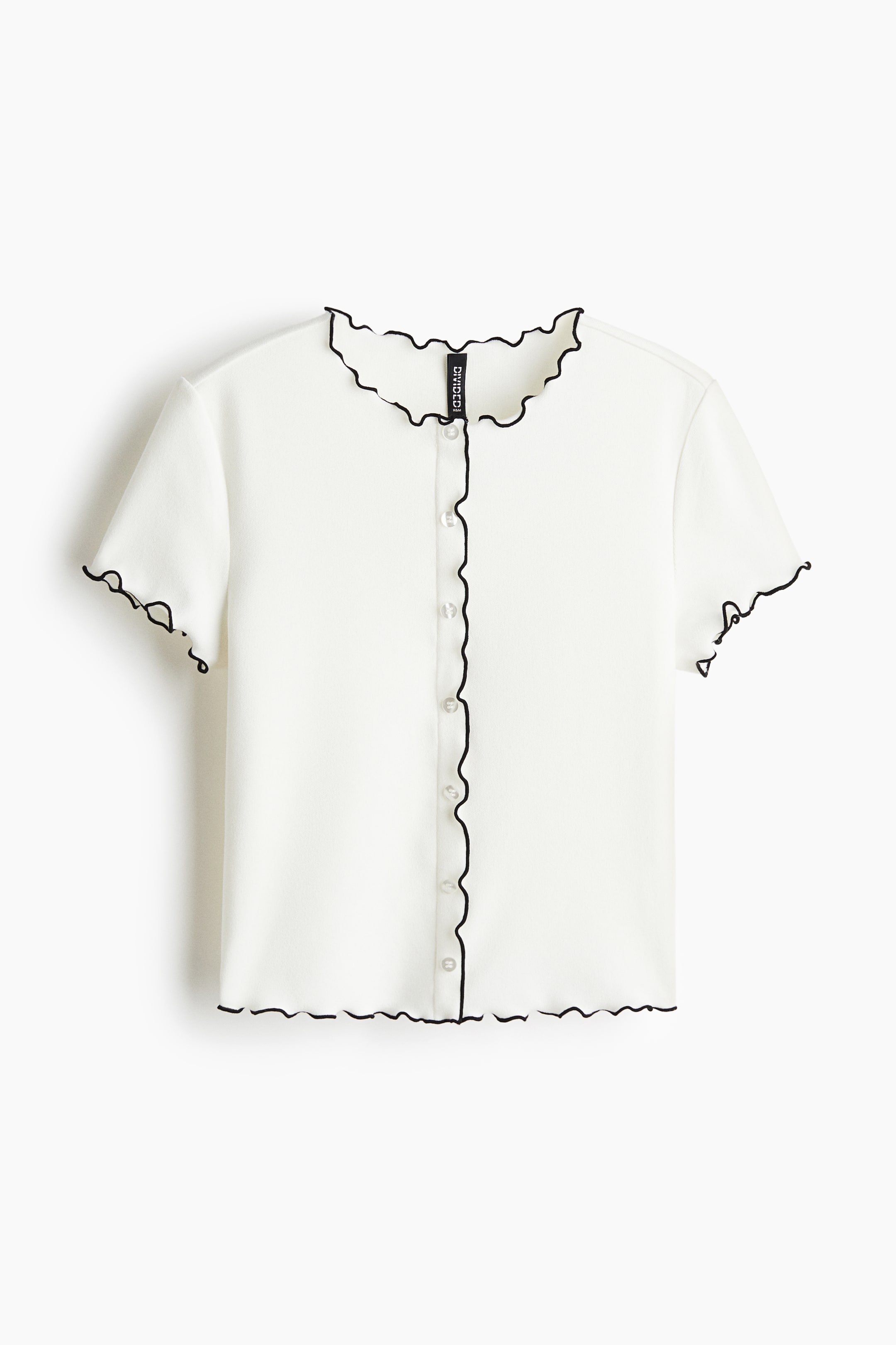 View larger image: A white short-sleeved button-up top is shown from the front, featuring a black lettuce-edge trim along its neckline, front placket, sleeve hems, and bottom hem, with seven clear buttons fastening the front.