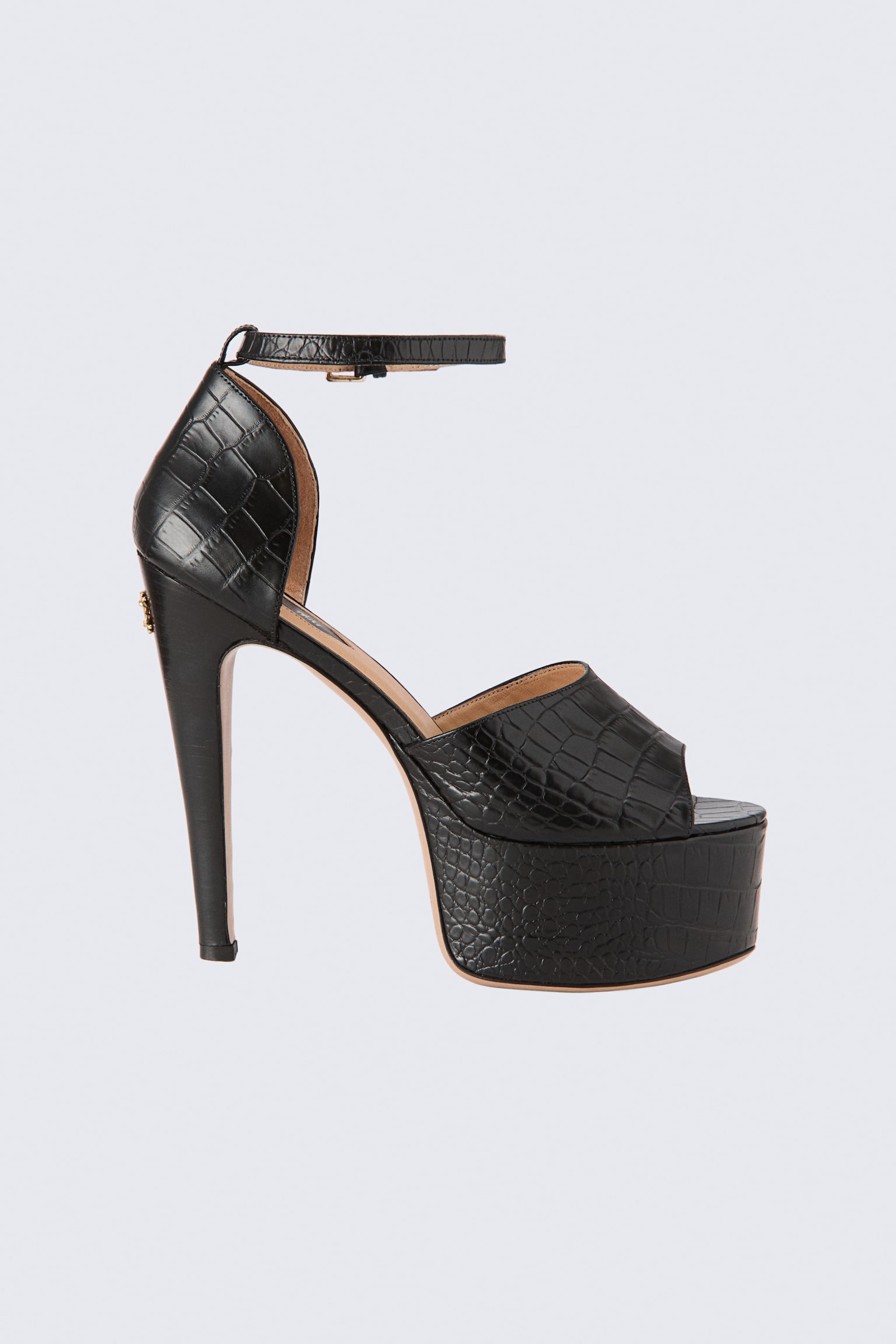 A black heeled leather platform sandal is displayed in side profile view, featuring a croc-embossed texture. The design includes a high stiletto heel, a thick platform sole, a wide front strap, a closed heel counter, and an adjustable ankle strap with a small buckle.
