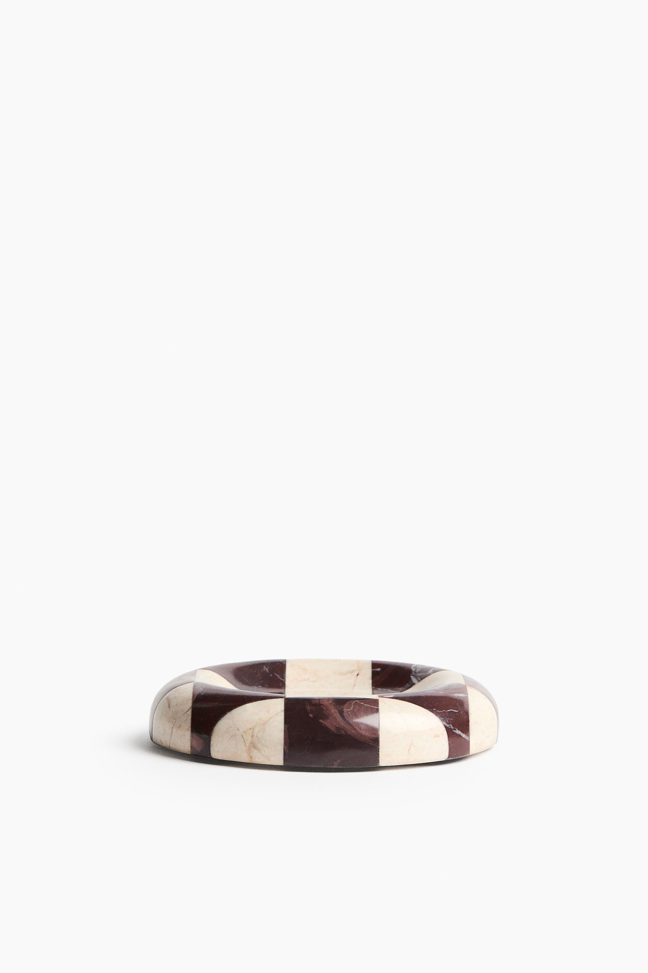 View larger image: A marble tray is showcasing a chequered pattern in brown and cream colours, with softly rounded edges. It is presented from a slightly elevated front angle, revealing its shallow, rounded form.