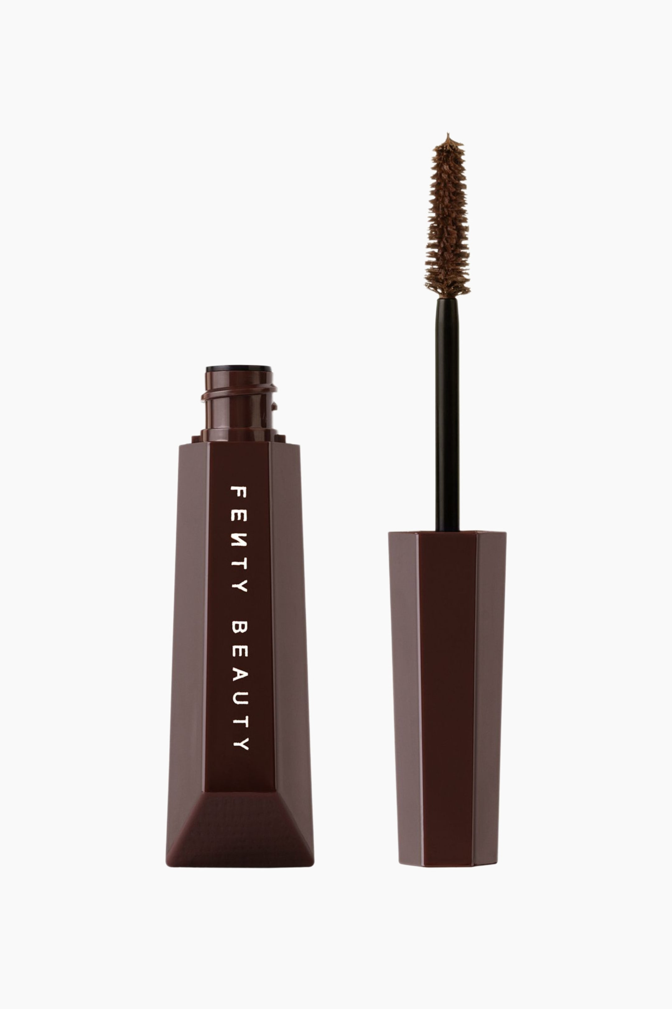 Visa större bild: Hella Thicc Volumizing Mascara står upprätt i en framifrån-vy och visar en öppen, mörkbrun hexagonal tub tillsammans med sin avt skruvade applikatorstav. Tuben har vertikal vit branding, medan staven visar en tät, avsmalnande borste med bruna borst.