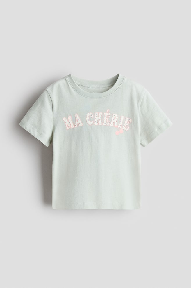 プリントTシャツ - ライトグリーン／Ma Chérie/イエロー／ニューヨーク/レッド／Mon Amour/ライトピンク／ユニコーン/ライトピンク／チェリー/ライトブルー／パリ/ピンク／ストロベリー - 1