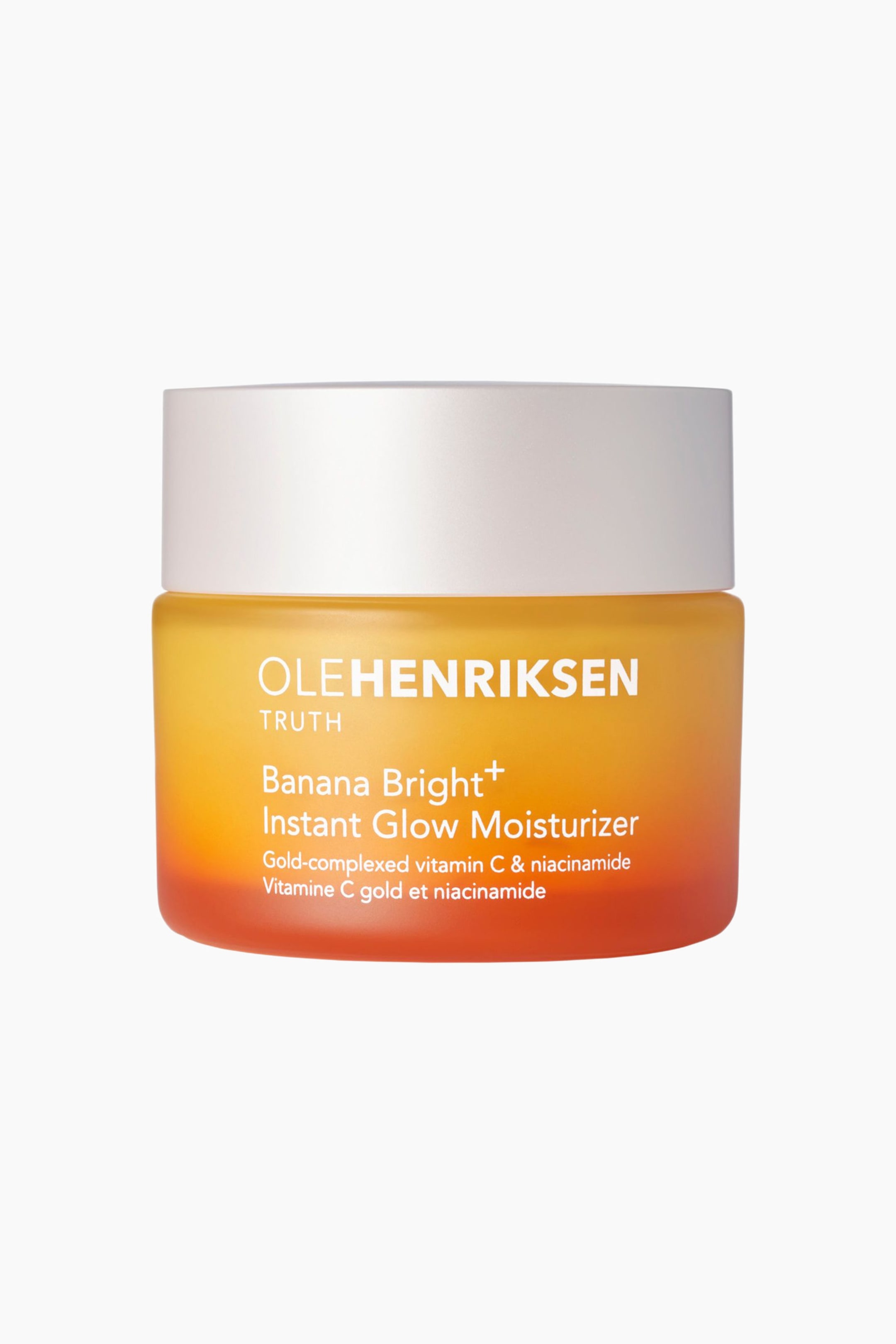 Se større billede: Olehenriksen Truth Banana Bright+ Instant Glow Moisturizer-krukken står oprejst og vender fremad. Den har et hvidt låg og en ombré-krop, der går fra gul øverst til orange nederst, med produktinformation trykt i hvid tekst på forsiden.