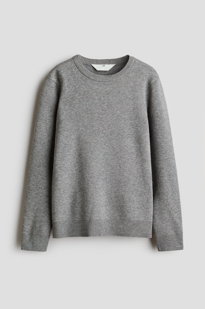 A grey fine-knit sweater is shown from the front, featuring a classic crew neckline, long sleeves, and ribbed detailing around the neckline, cuffs, and hem. - 1