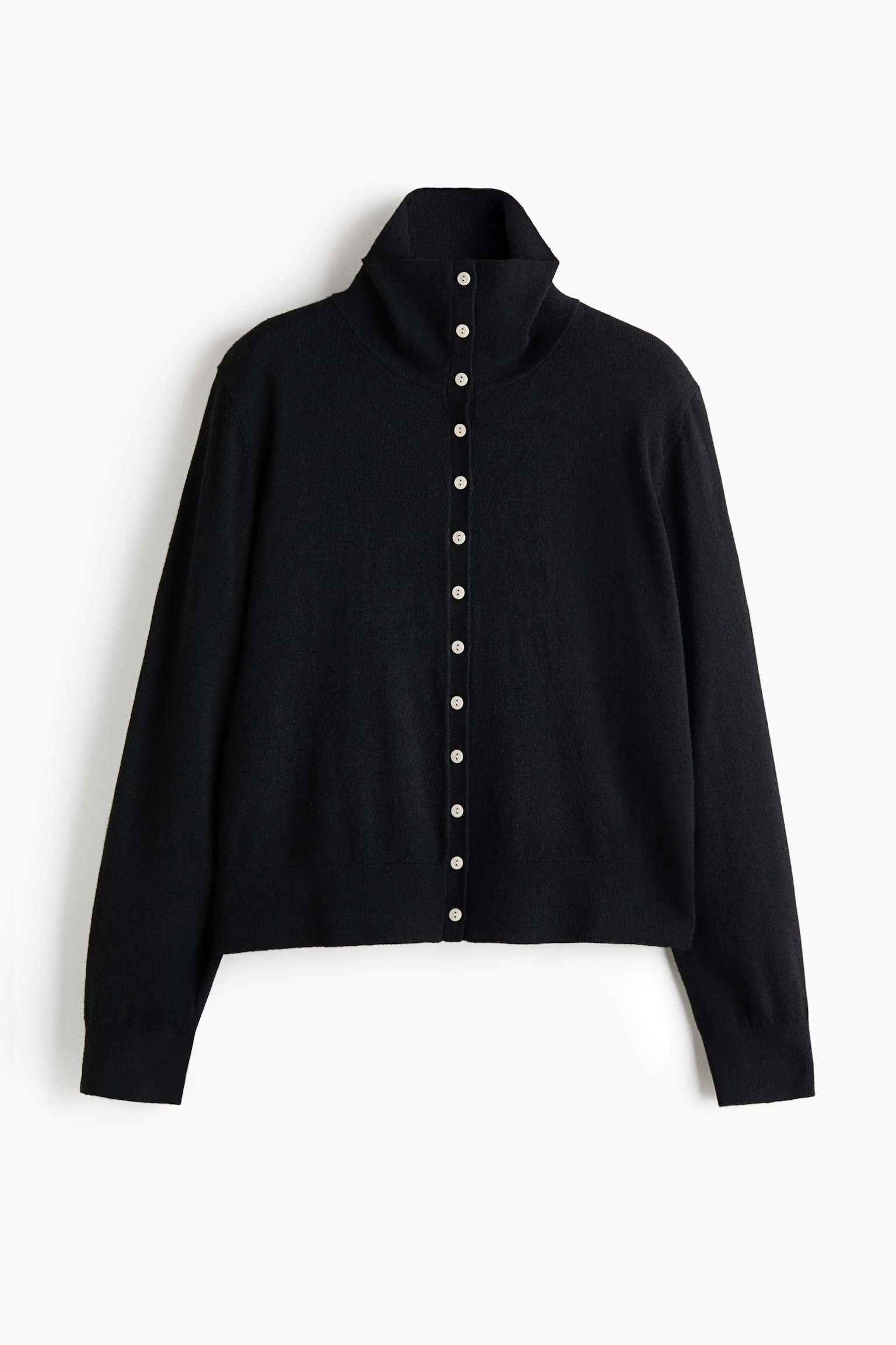A black fine-knit cardigan is shown from the front, featuring a high neck, a full button-down front with contrasting light-coloured buttons, and long sleeves. The garment features ribbed detailing at the cuffs and hem.
