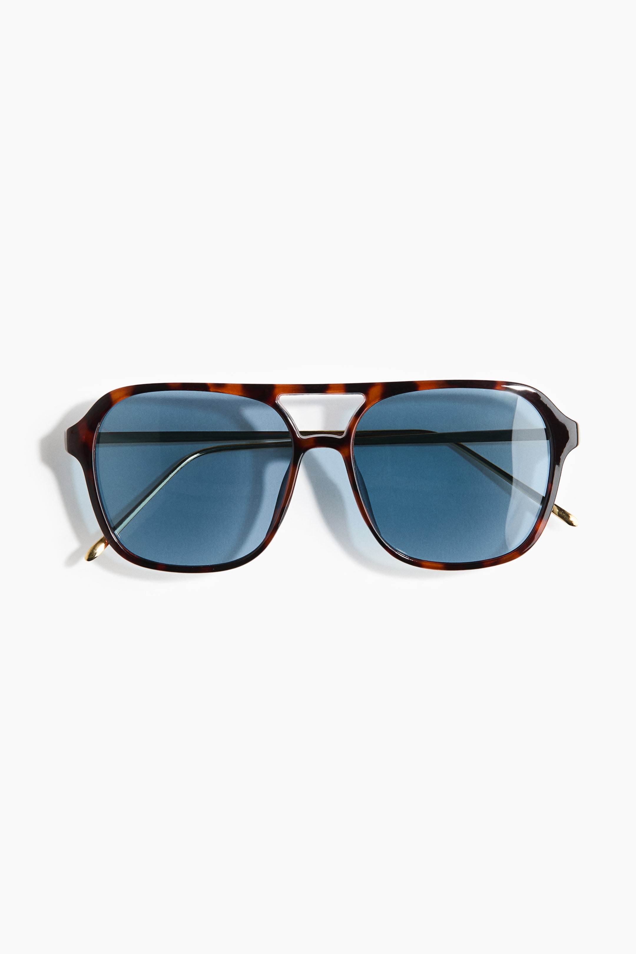 View larger image: Aviator-style sunglasses are presented facing front, showcasing a tortoiseshell plastic frame with a double bridge and slender metal sidepieces. They come equipped with tinted blue polarised plastic lenses.