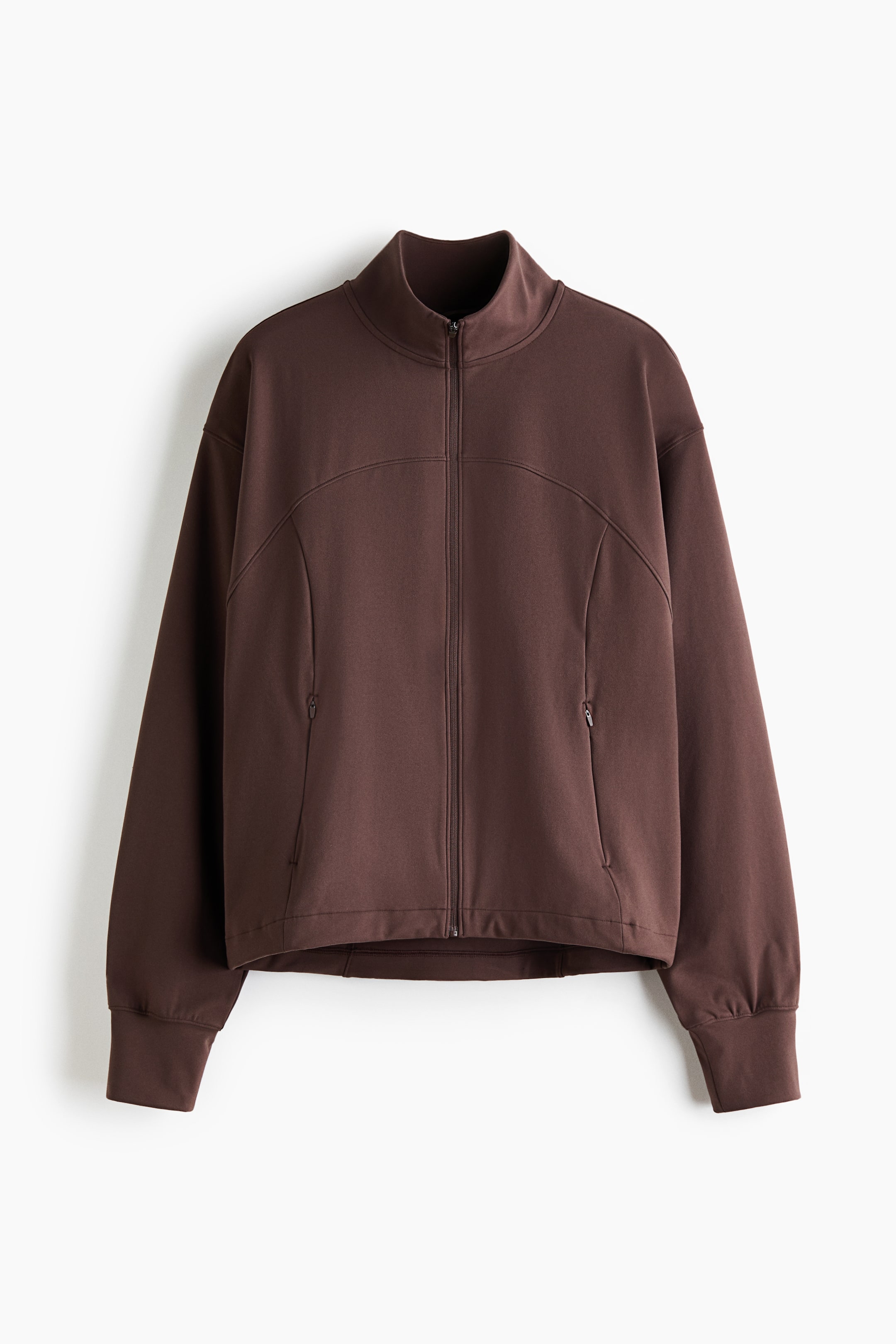 View larger image: A dark brown zip-up jacket is hanging facing the front, featuring a mock neck, a full-length front zipper, and curved seam detailing across the chest. It is displaying drop shoulders, long sleeves with wide ribbed cuffs, and zippered side pockets.