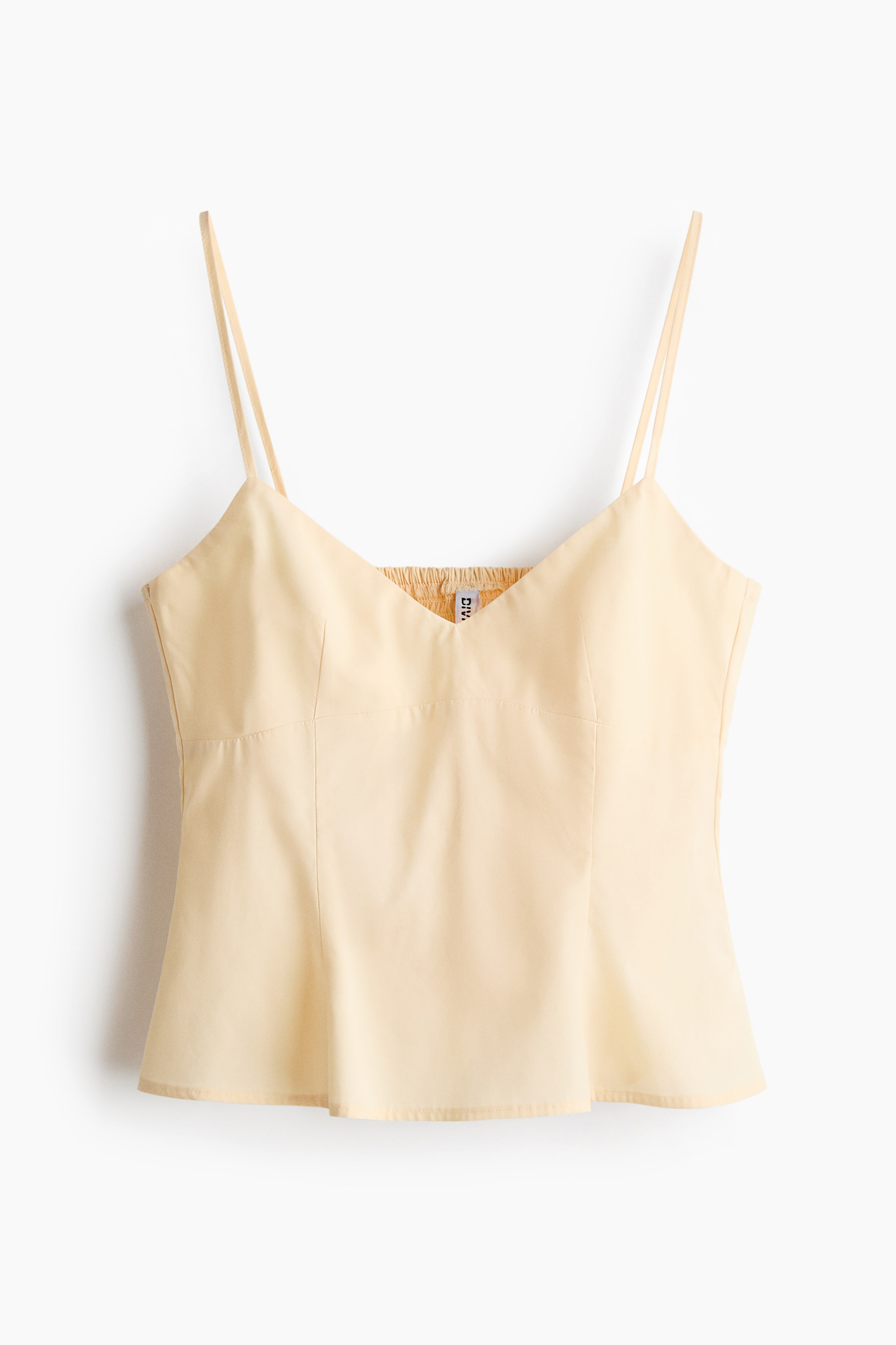 Ampliar la imagen: Un top tipo camisole amarillo pálido muestra su parte frontal, con finos tirantes tipo spaghetti y un escote en V. Presenta un cuerpo entallado con costuras verticales y un sutil vuelo en el dobladillo, con fruncido (shirring) visible en la parte posterior del escote.