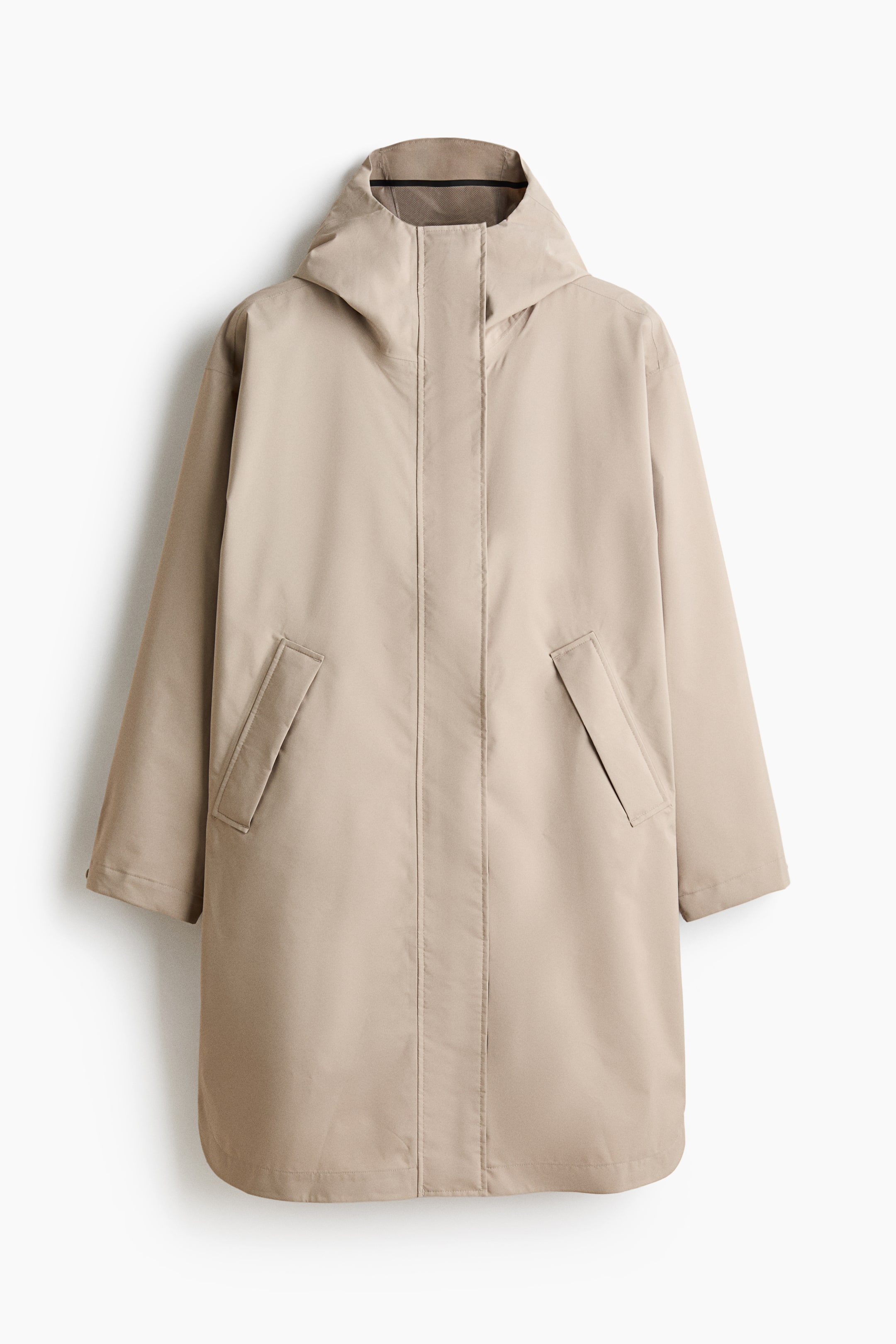 View larger image: A beige mid-length parka is showcased from the front, featuring an integrated hood, a central concealed placket fastening, and two angled flap pockets.