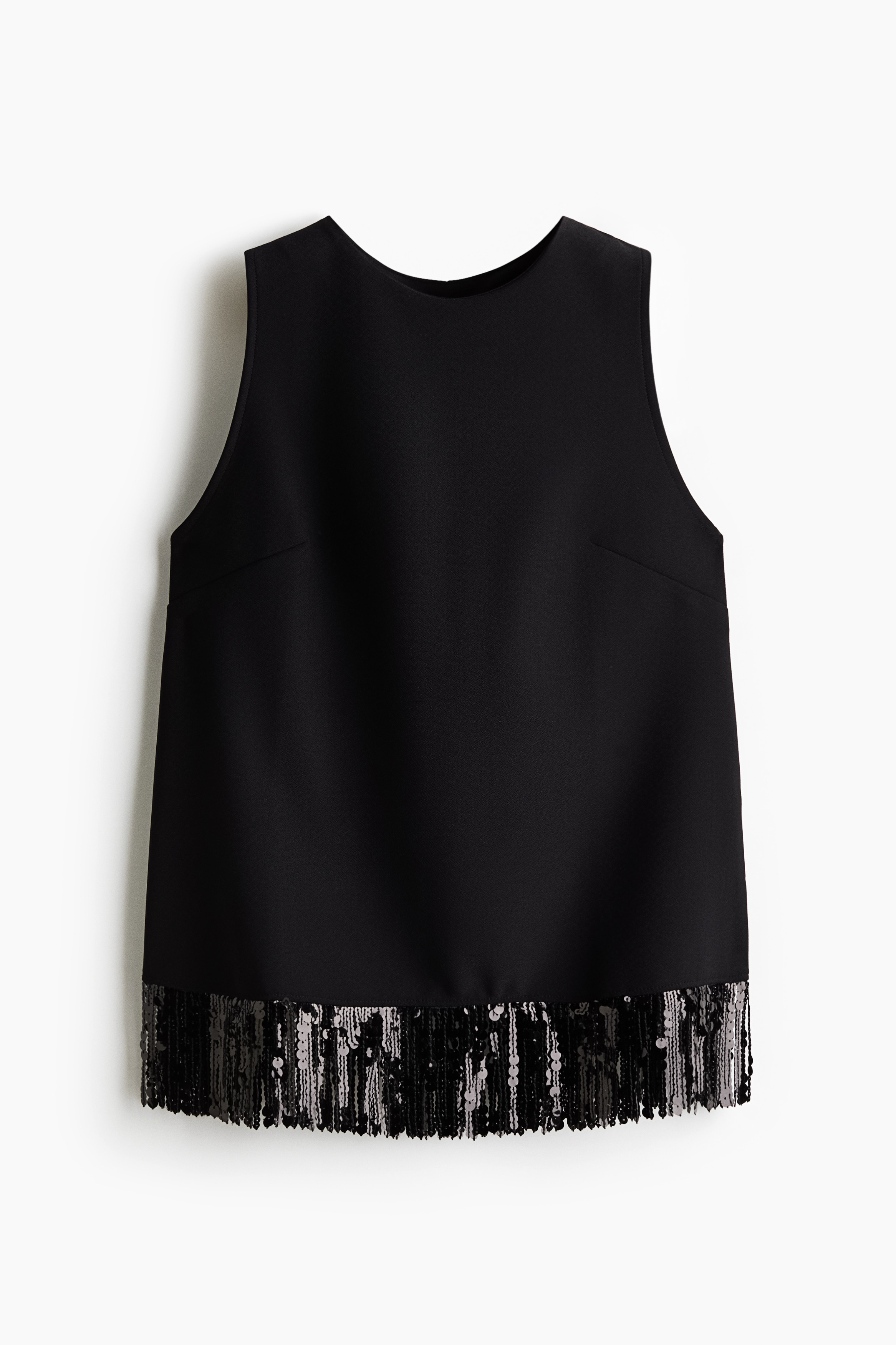 A black sleeveless top featuring a sequined fringe hem is being worn by the model, who is posing with one arm raised toward her shoulder.