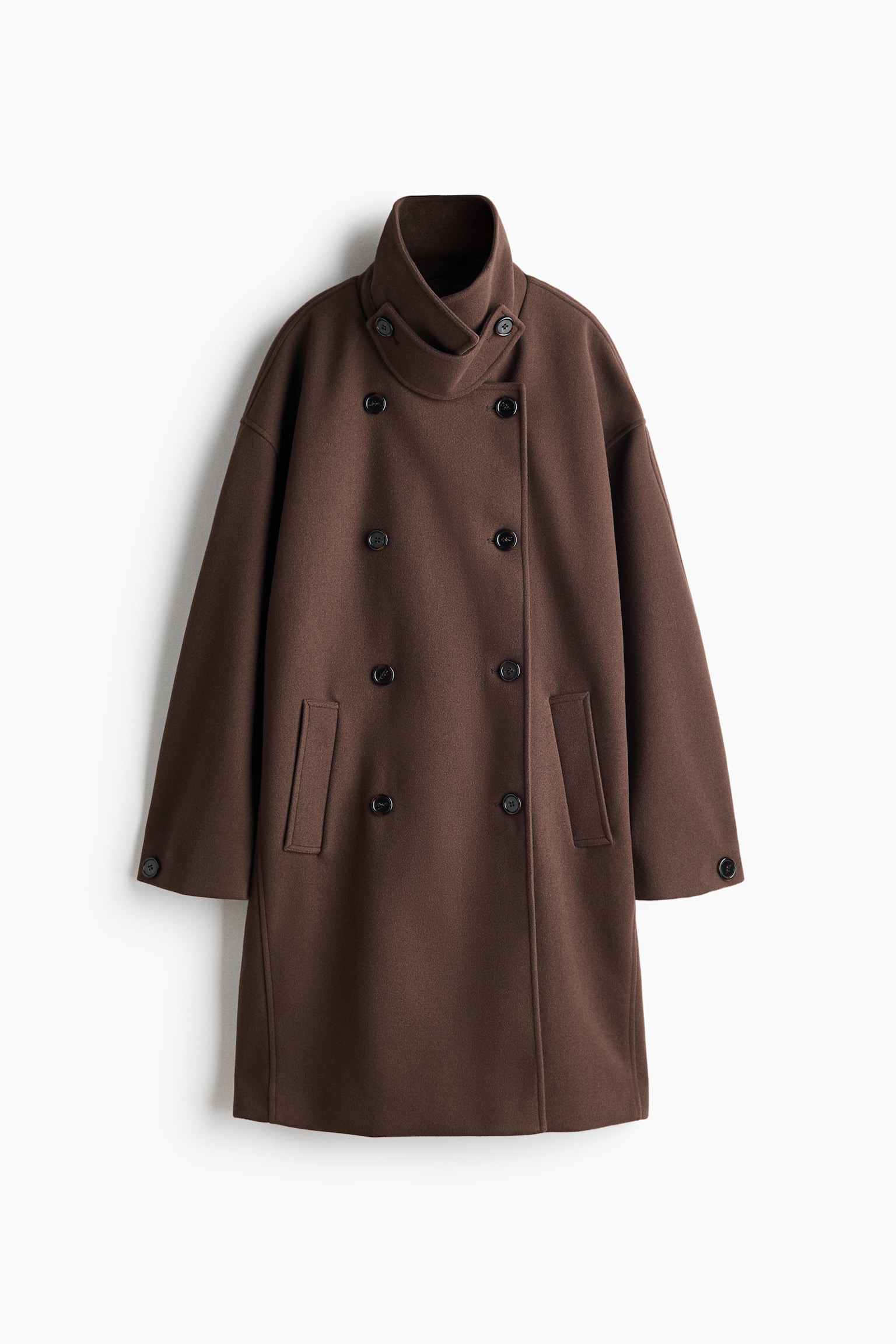 A dark brown, double-breasted felted coat is hanging in a front view, featuring a high funnel collar with a buttoned throat latch. The garment showcases dark buttons down the front, vertical welt side pockets, and long sleeves with buttoned cuffs.