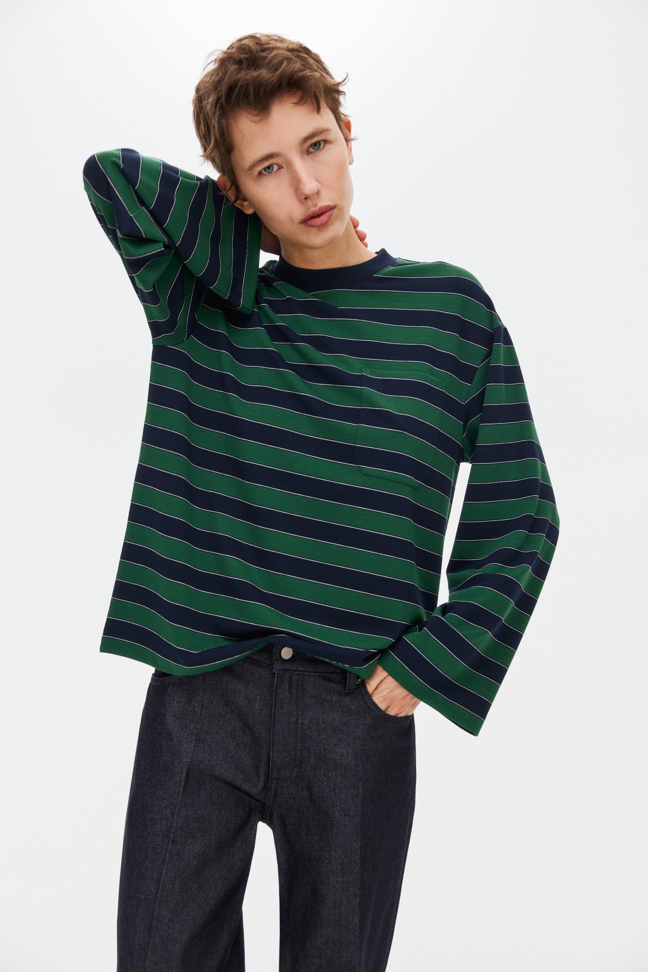 View larger image: A long-sleeved shirt displays alternating green and navy-blue horizontal stripes with thin white accents. It features a loose fit, wide sleeves, a ribbed crew neck and a front-facing patch chest pocket on the left.