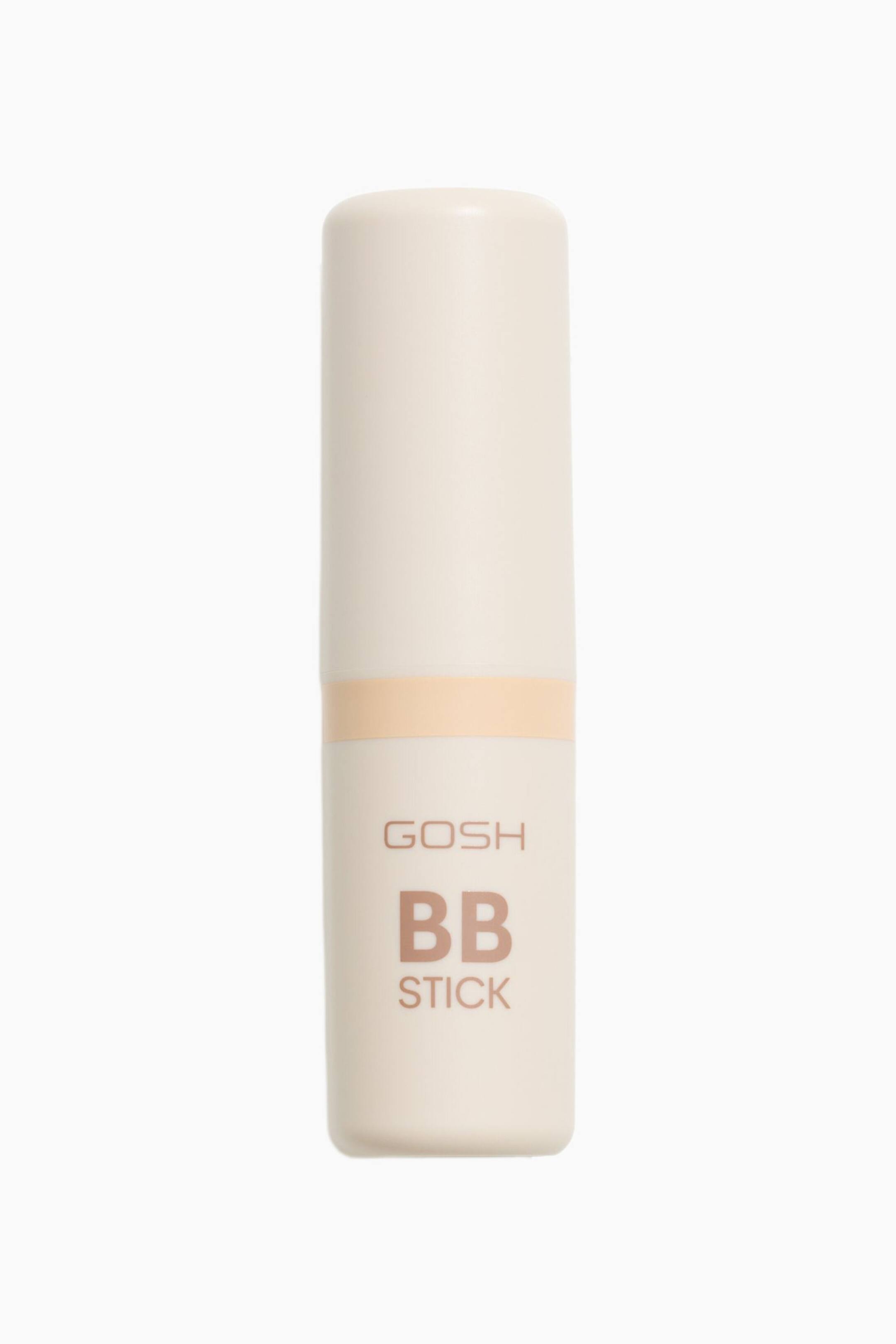 Visa större bild: En GOSH BB-sticka presenteras i ett cylindriskt, ljuskrämfärgat hölje. Ett persikofärgat band omger dess mittsektion, och orden 'GOSH BB STICK' visas i dämpad brun text på framsidan.