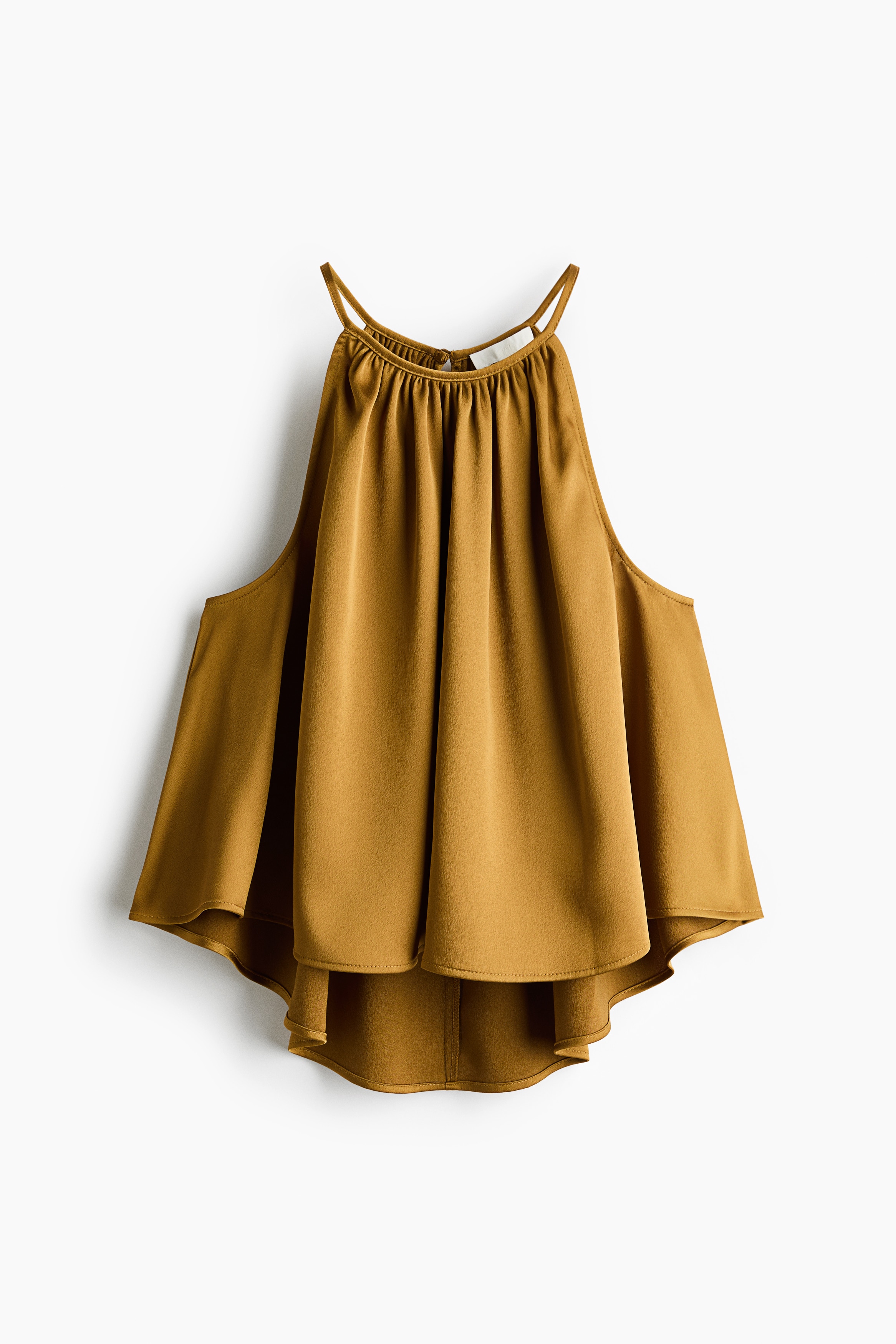 A short, sleeveless mustard yellow top featuring a loose fit, gathered high neckline, and high-low hem is worn by the model. The model is pairing the top with black trousers while holding a black leather handbag.