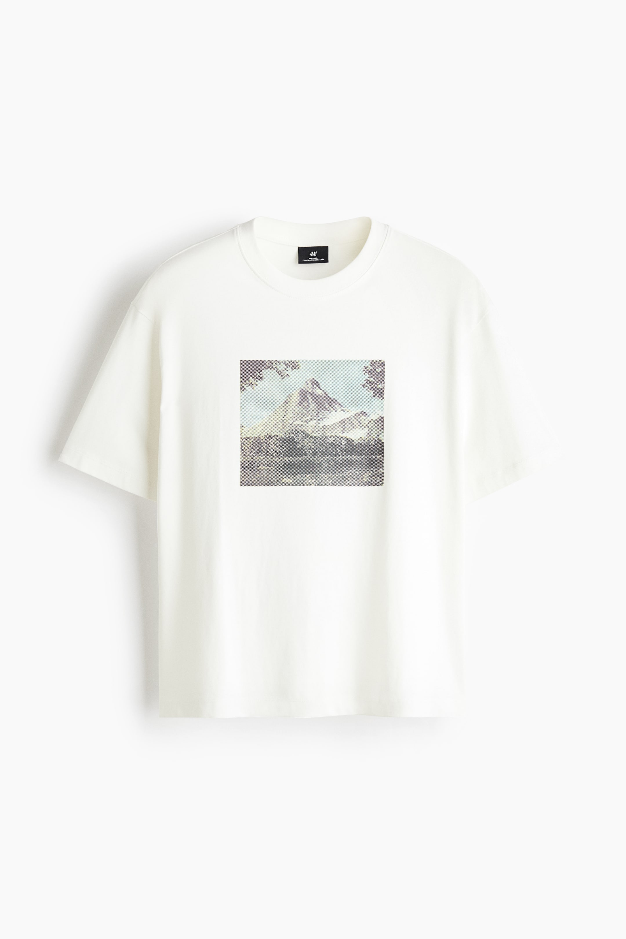 View larger image: An off-white crewneck t-shirt is facing front, featuring a relaxed fit, short sleeves, and a ribbed neckline. A square graphic print depicting a snow-capped mountain landscape with trees is centered on the chest.