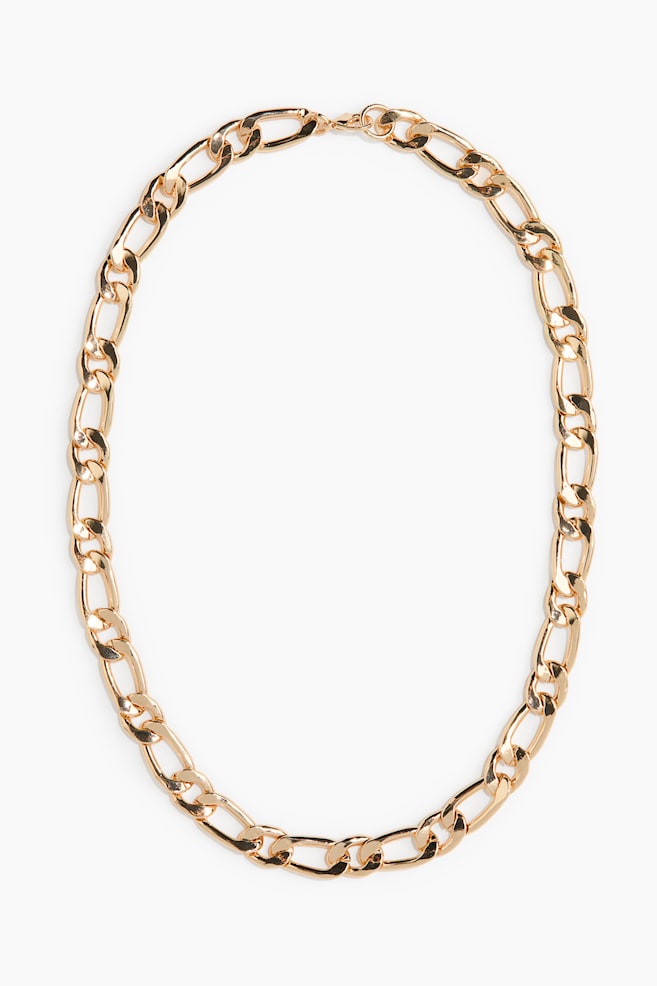 The gold-toned Figaro chain necklace features alternating elongated oval links and shorter circular links. It forms an oval shape, with a visible lobster clasp closure. - 1