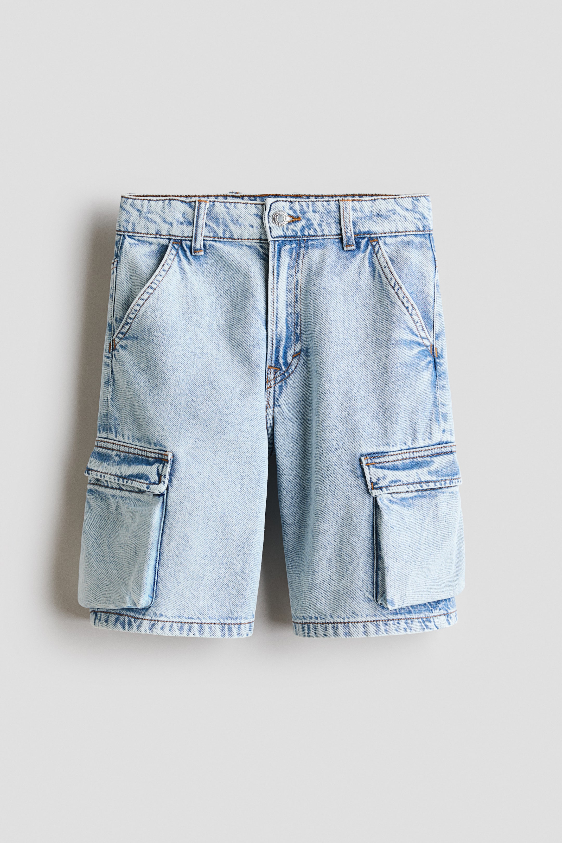 View larger image: Light blue acid-wash denim cargo shorts are shown from the front, featuring a button and zip fastening, belt loops, slanted front pockets, and large flap cargo pockets on both sides.
