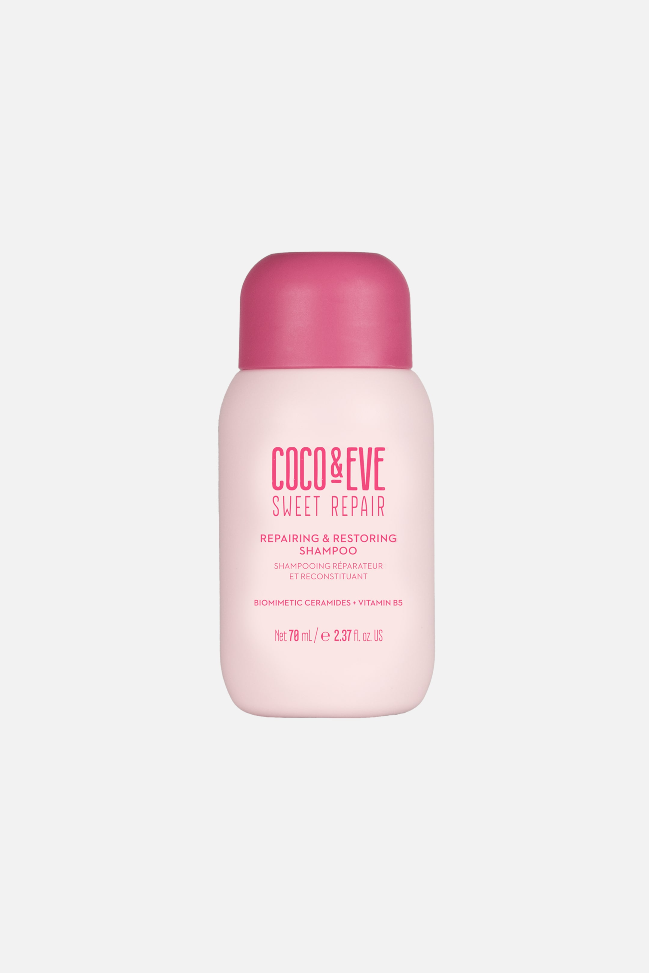 Visa större bild: En flaska Coco & Eve Sweet Repair Repairing & Restoring Shampoo står upprätt och vänd framåt. Produkten har en matt, ljusrosa kropp med en rundad siluett, toppad med ett mörkare rosa kupollock och med tryckt text på framsidan.