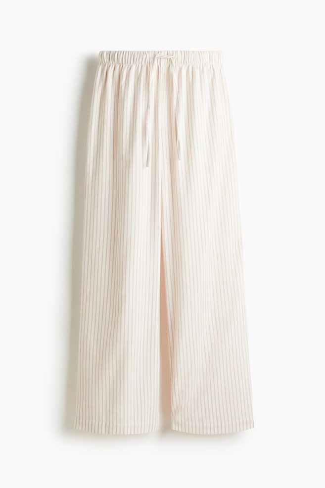 Pyjama bottoms are presenting front, made of off-white cotton flannel with thin, pale brown vertical stripes. They are featuring straight legs and a low, drawstring waist with covered elastication. - 1