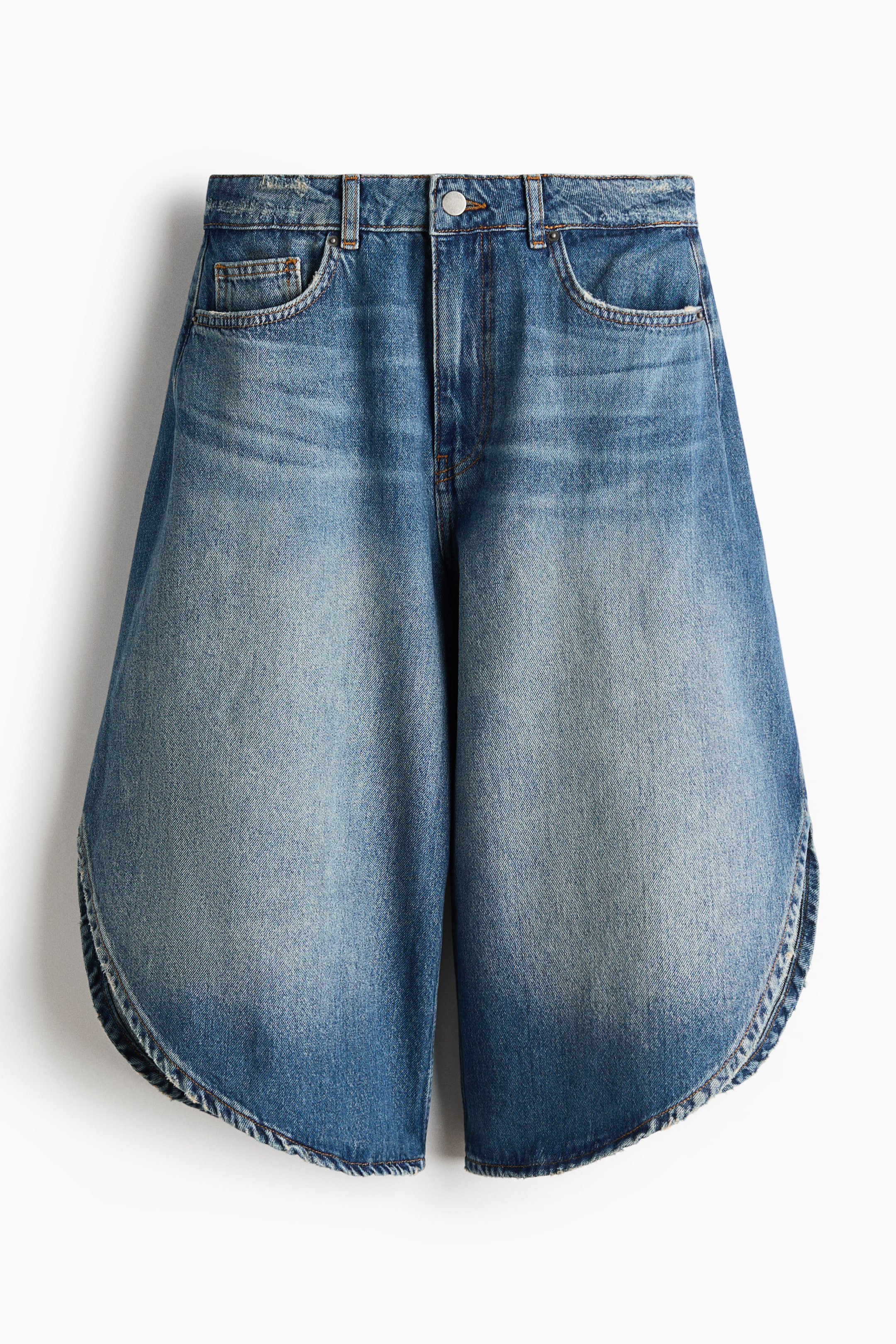 View larger image: Five-pocket shorts crafted from rigid cotton denim are showcased from the front, boasting a regular waist with a zip fly and button. They feature hard-worn details, wrapover sides, and rounded hems.