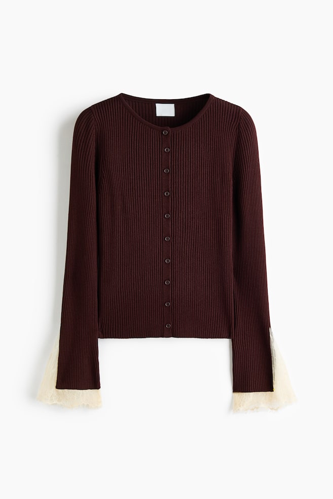 This dark burgundy, ribbed-knit cardigan is shown from the front, featuring a round neckline, a button-front closure, and long sleeves that end in flared, cream-coloured lace-trimmed cuffs. - 1