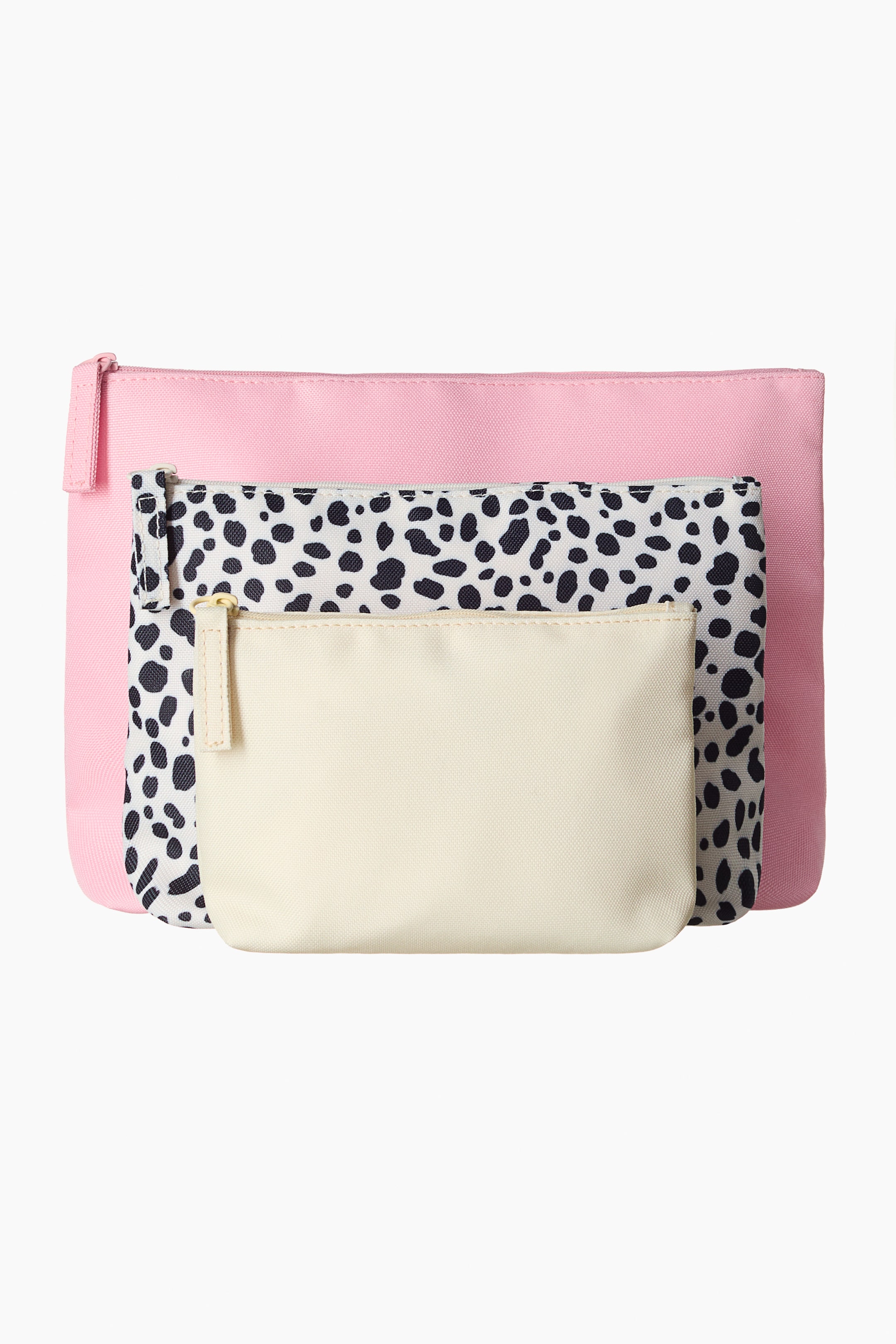 View larger image: A versatile set of three wash bags is presenting in a front view, layered from largest to smallest. The largest bag is pink, the middle bag is featuring a black spotted pattern on a white background, and the smallest bag is off-white. Each bag is having a zip closure at the top with a matching fabric pull tab.