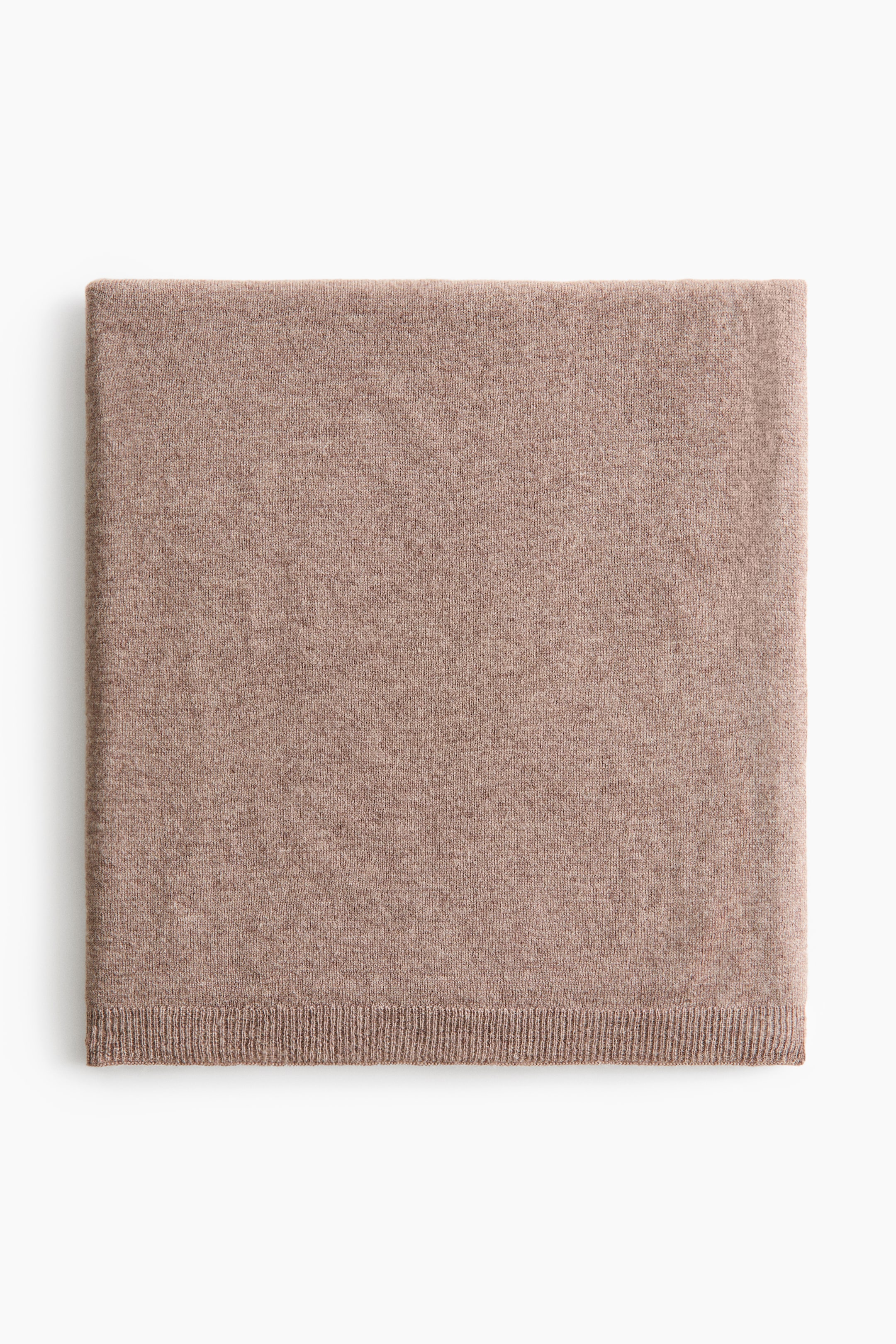 View larger image: A light brown baby blanket is displayed front-facing as a flat, rectangular piece of soft, fine-knit wool, featuring ribbing at its short ends.