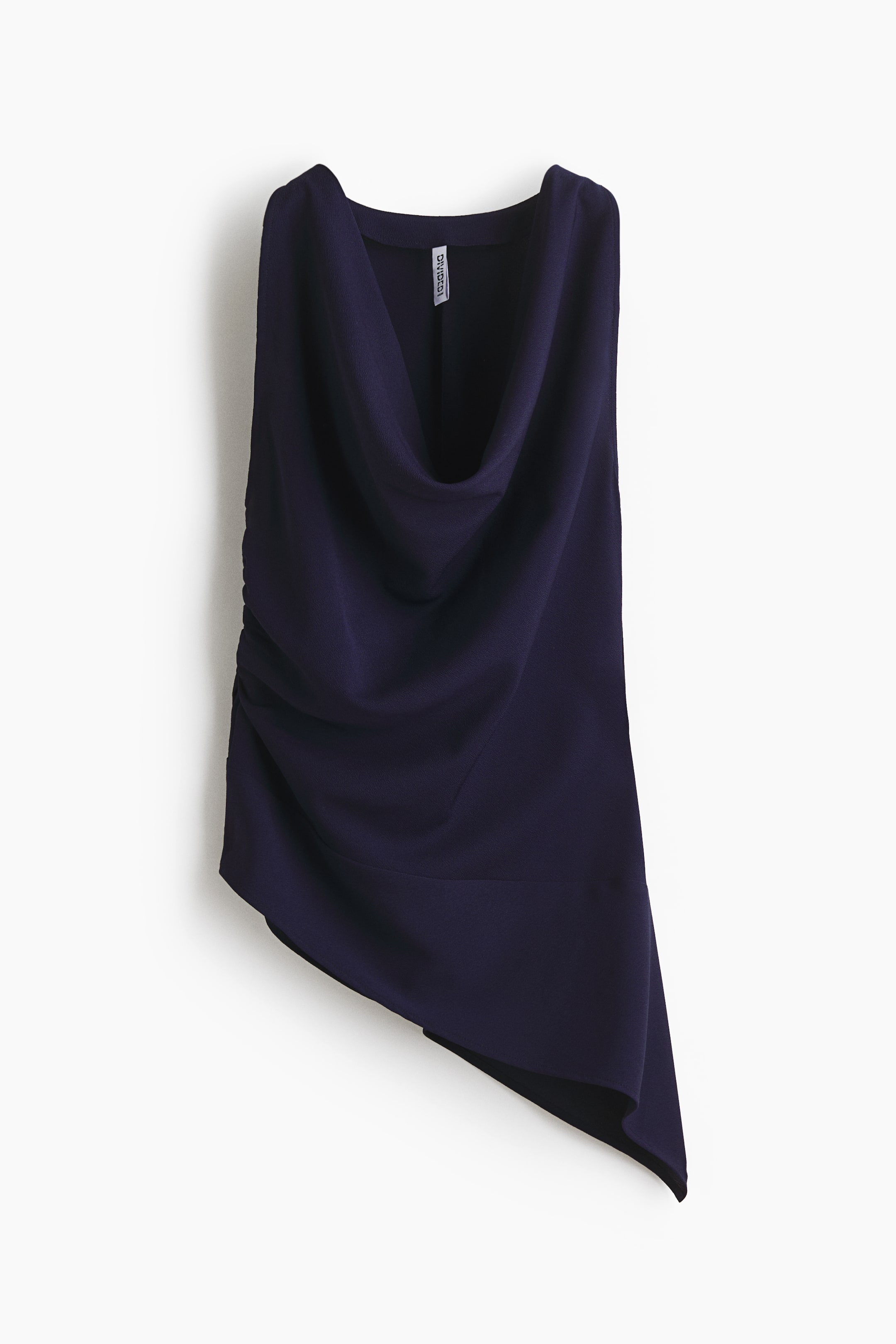 View larger image: The dark blue sleeveless top is facing forward, featuring a draped cowl neckline, gentle draping on its right side, and ruching on its left, culminating in an asymmetrical hemline.