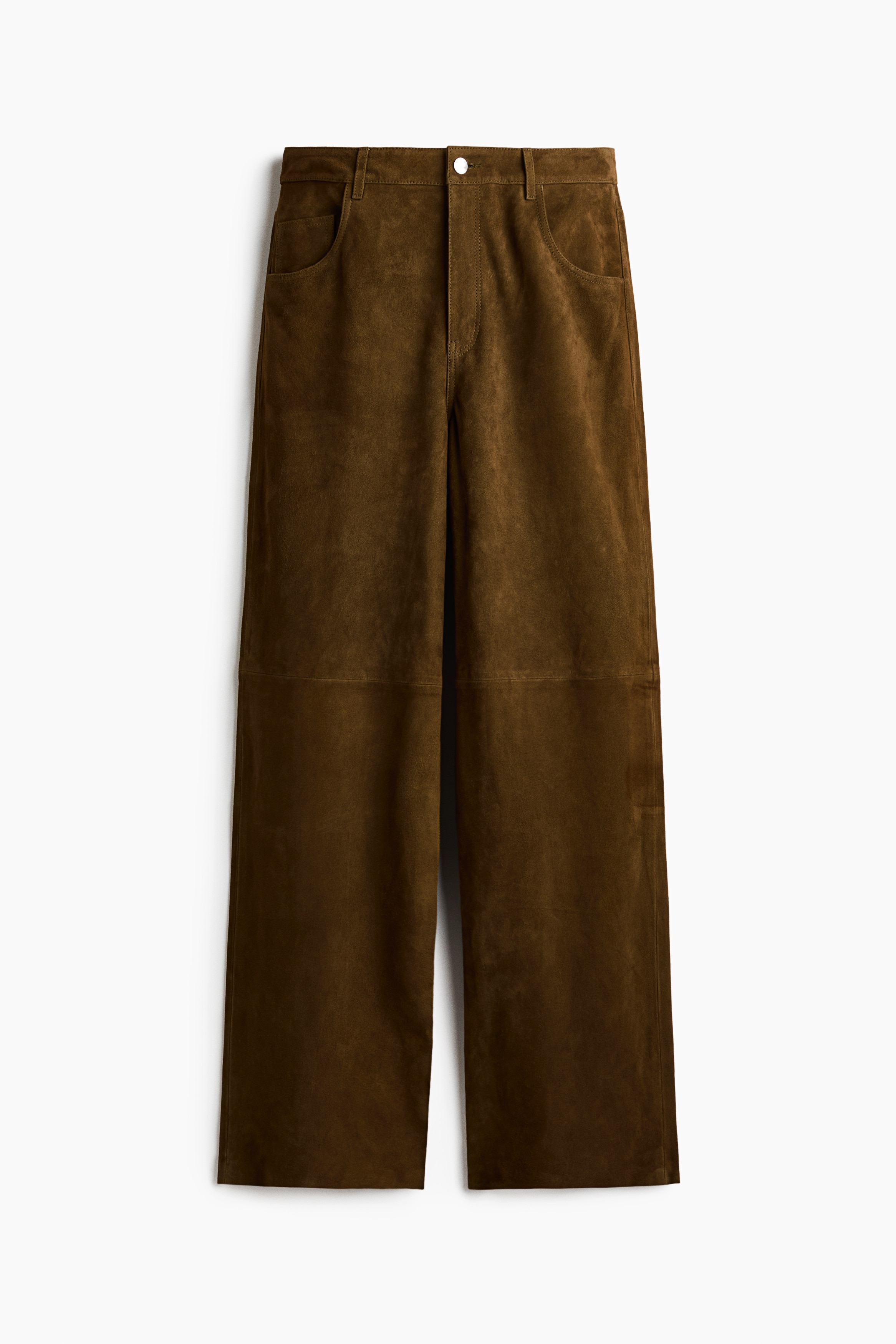 Brown suede five-pocket trousers featuring a straight-leg silhouette and visible seams at the knees are worn by the model. The trousers are styled with a matching suede shirt, a black leather belt with an ornate silver buckle, and black pointed-toe boots, with the model standing and placing their hands in the pockets.