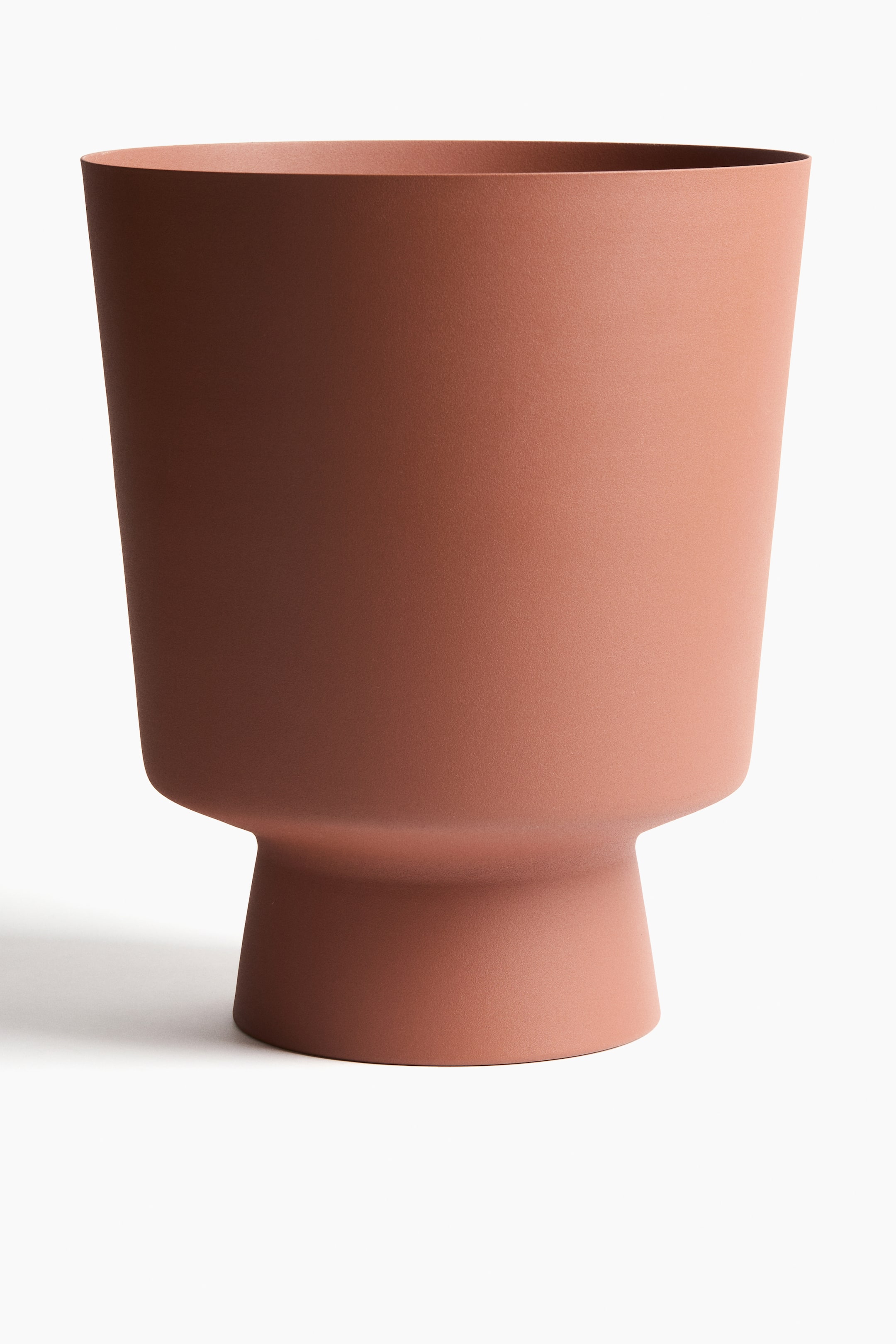 View larger image: A large plant pot is depicted from the front, showcasing a reddish-brown painted metal finish with a subtle matte texture. It is crafted with a wide, open top, narrowing down to a slender, pedestal-like base.